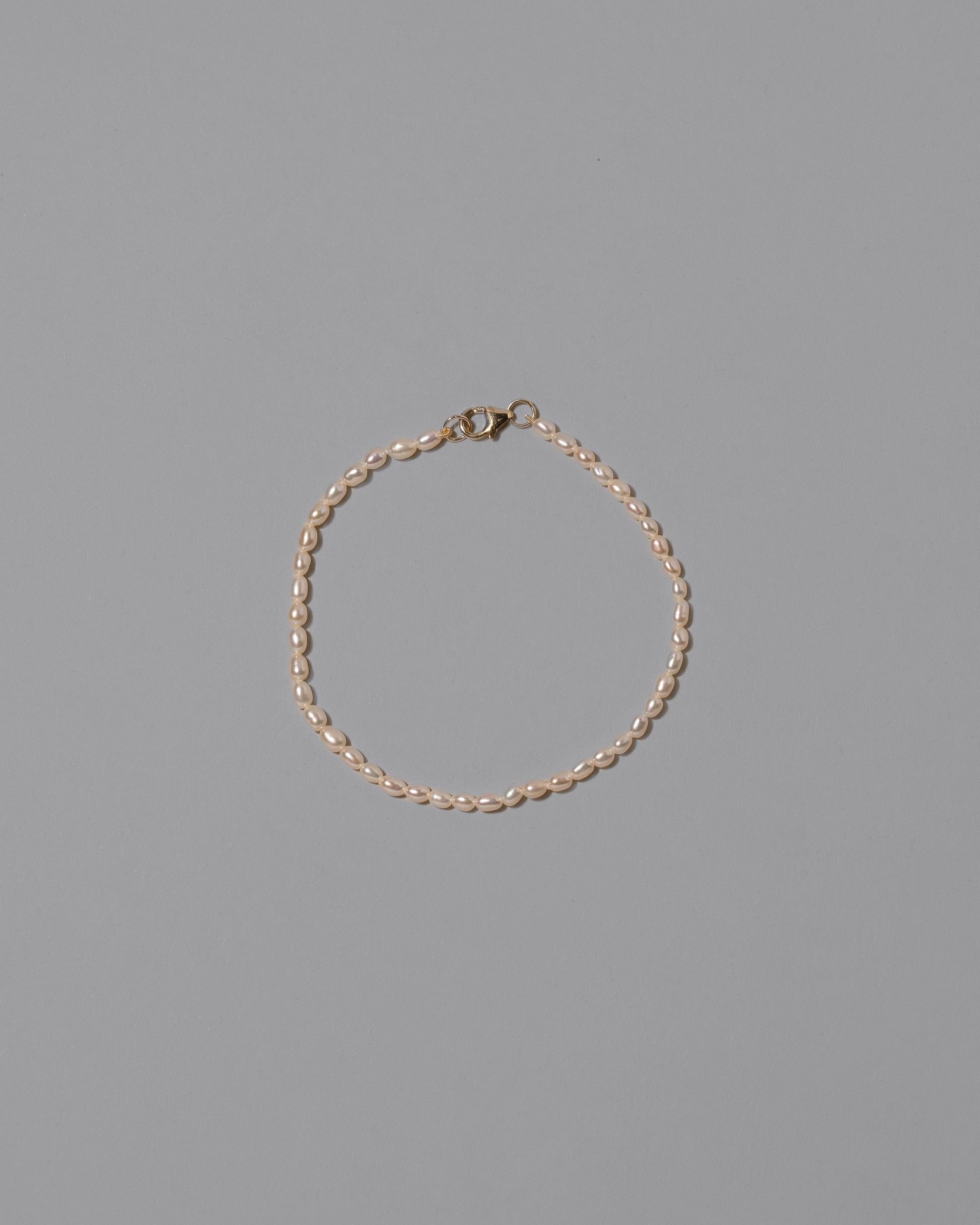 White Oval Seed Pearl Bracelet on light color background.