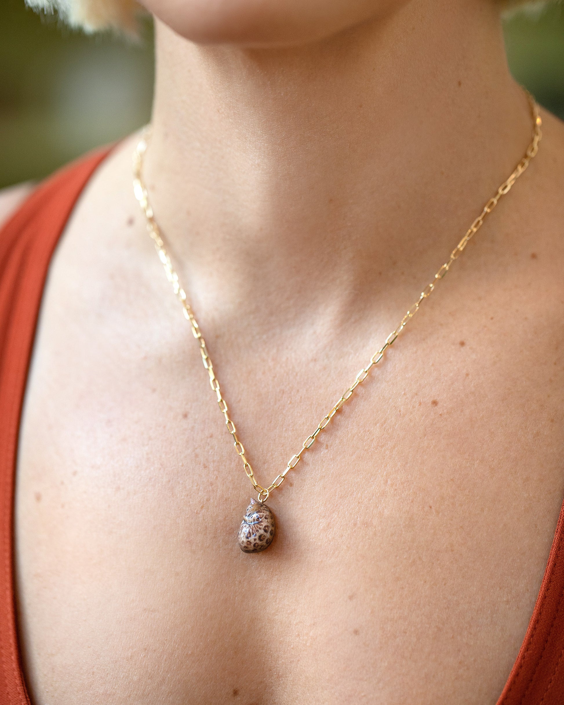 Curled-Up Cat Charm paired with 3.5mm Beveled Oval Chain Necklace on model.