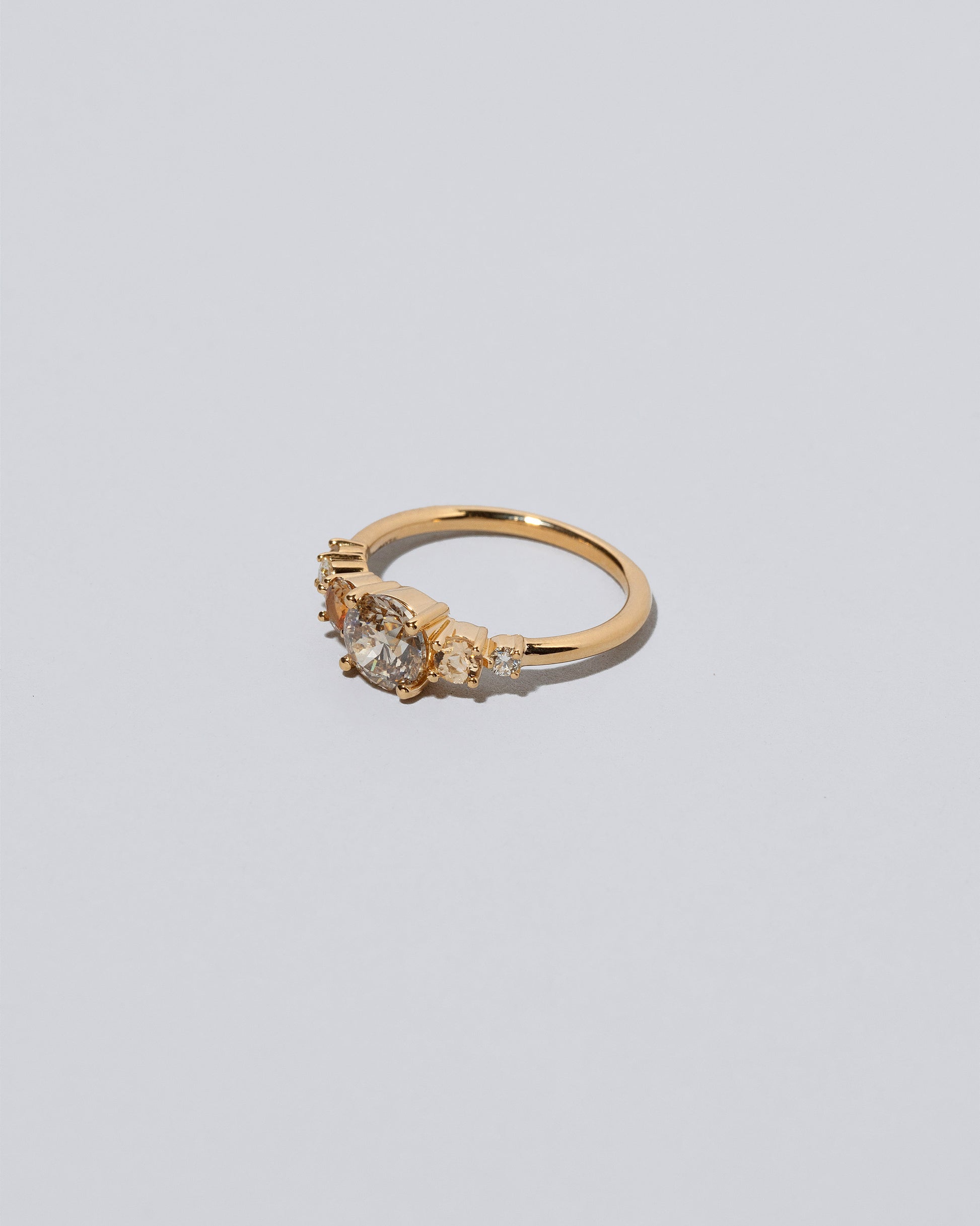 View from the side of the Champagne Diamond Capella Ring on light color background.