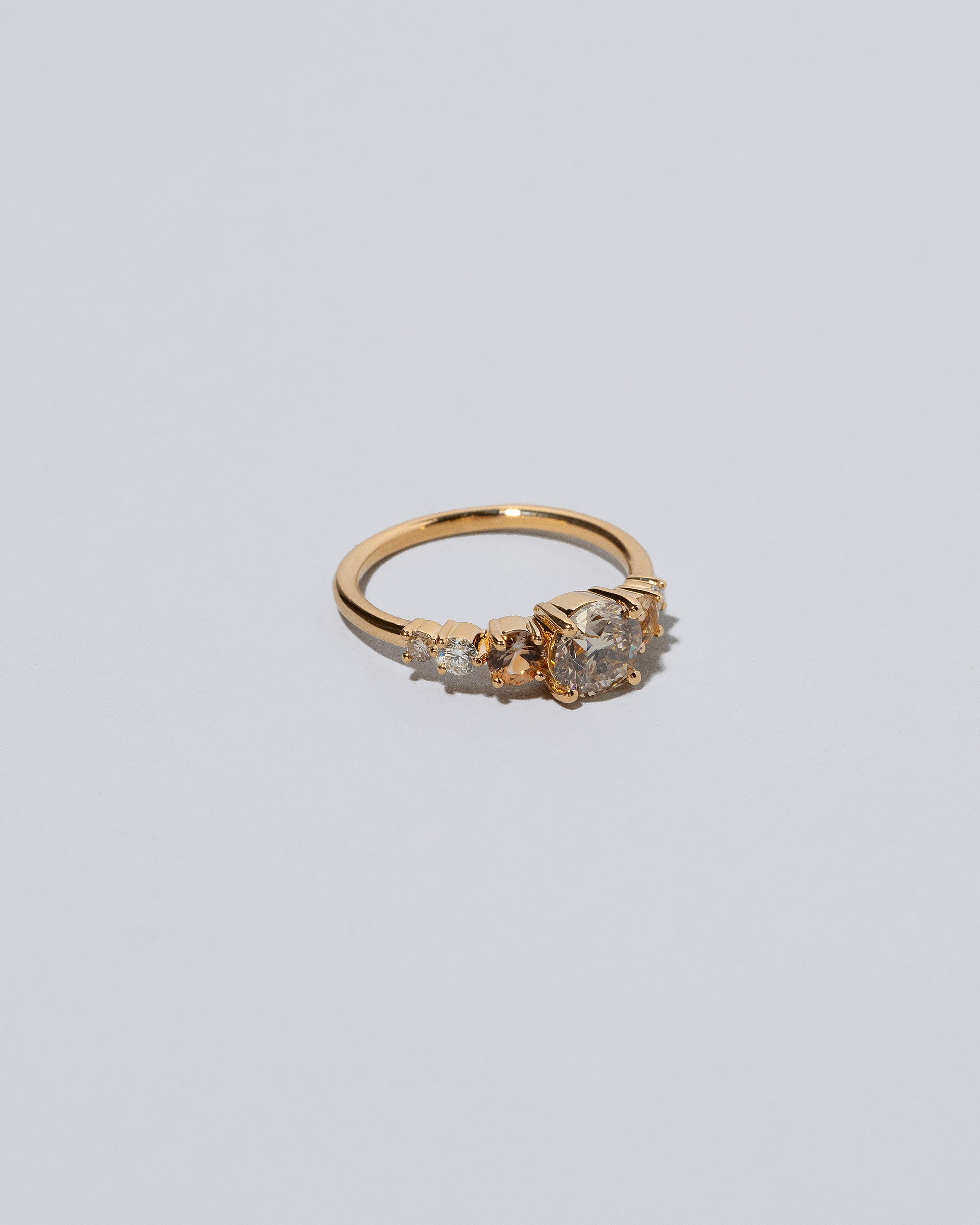 View from the side of the Champagne Diamond Capella Ring on light color background.