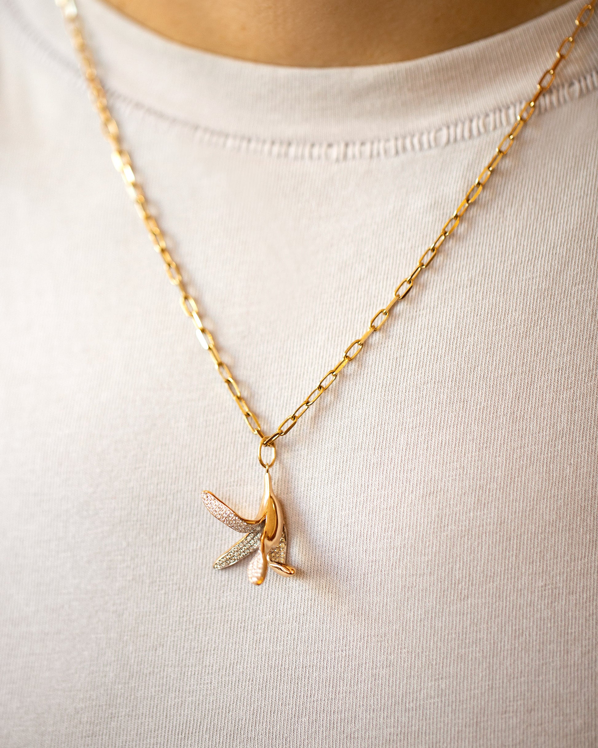 2.2mm Beveled Oval Chain Necklace and Banana Peel Charm on model.