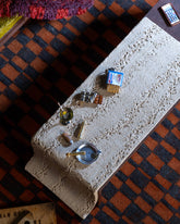 Styled image featuring the Chocolate Bar Charm, with the Joint Charm, Lit Joint Charm, Dirty Martini Charm and Instant Ramen Charm.