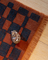 Styled image featuring the Curled-Up Cat Charm.