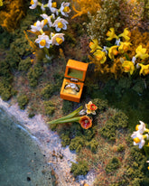 Styled image featuring the Daffodil Charm, with the California Poppy Charm and Luna Ring Charm.