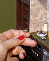 Styled image of the Dirty Martini Charm and Passionfruit Charm.