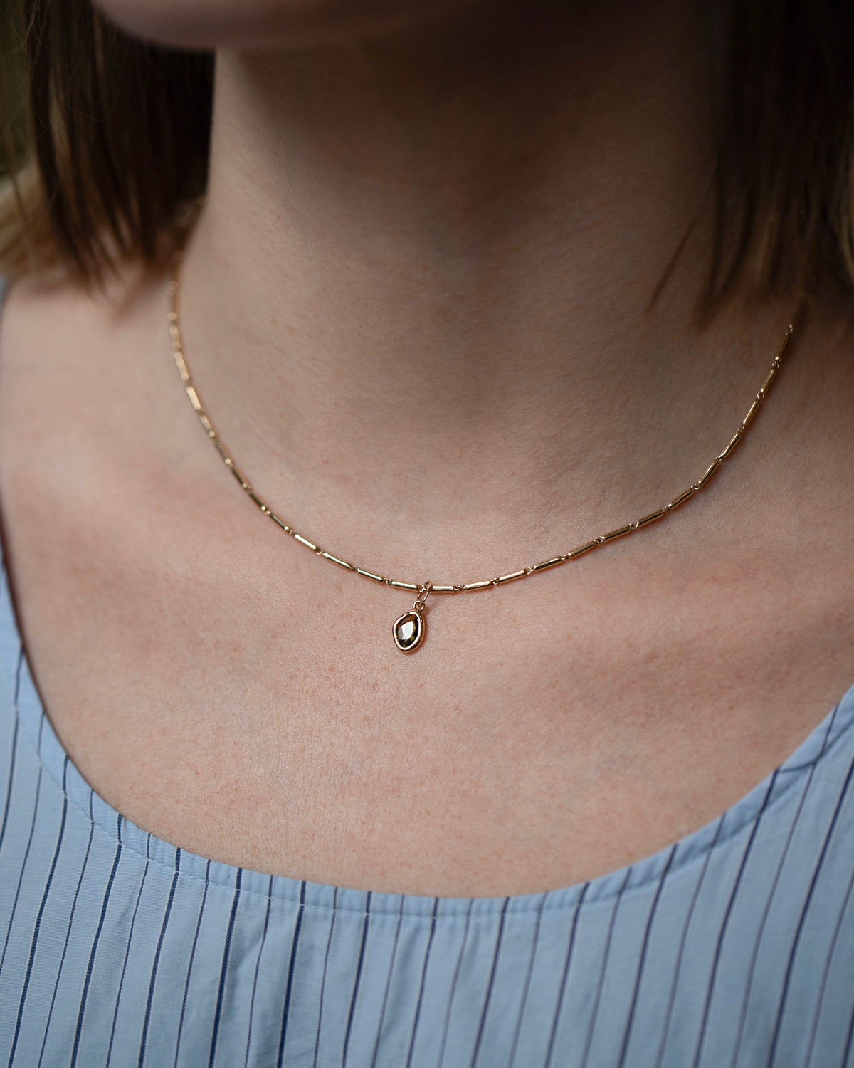 Gold Butter Chain Necklace and Green Sapphire Gusher Charms on model.