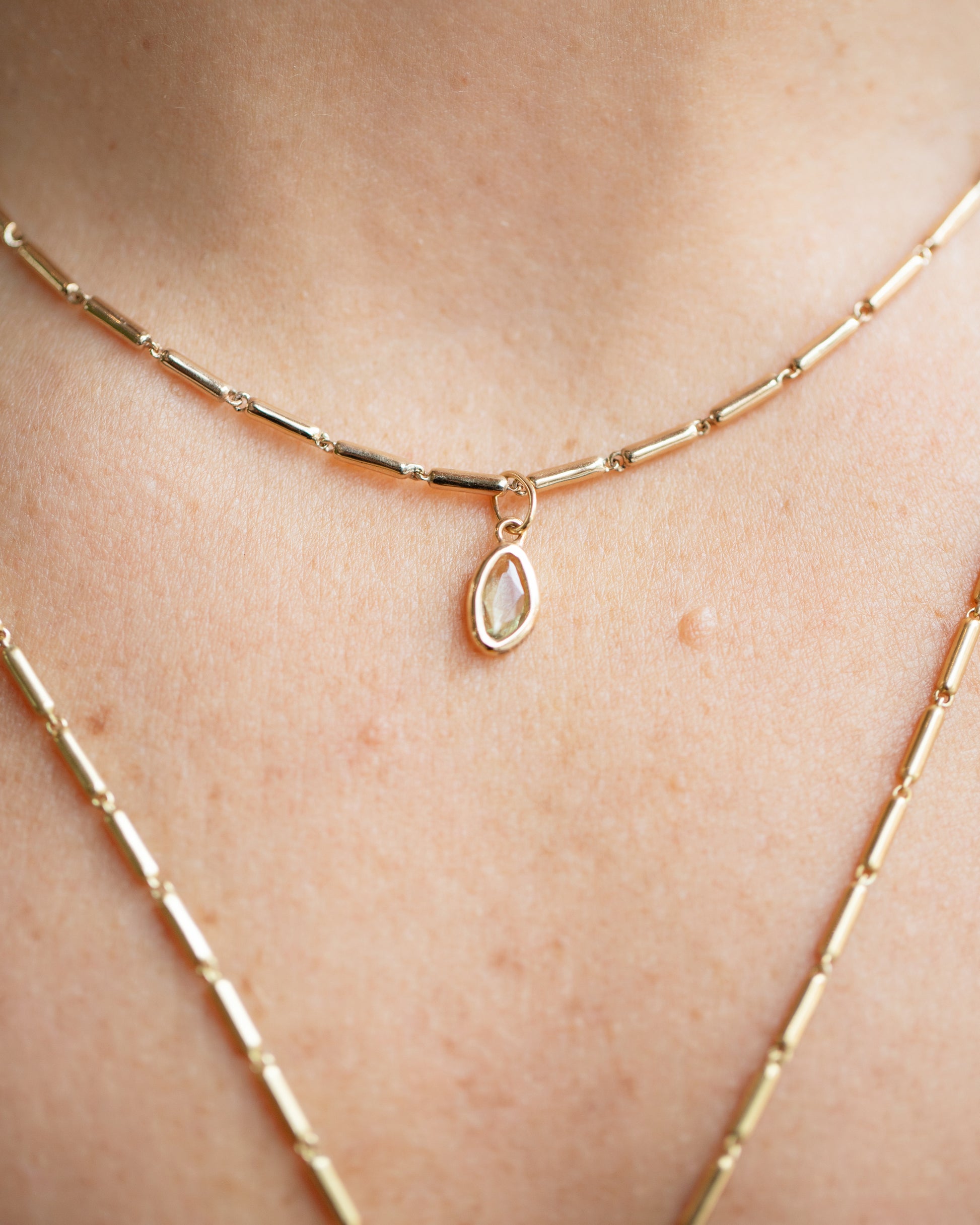Yellow Sapphire Gusher Charm and Gold Butter Chain Necklace on model.