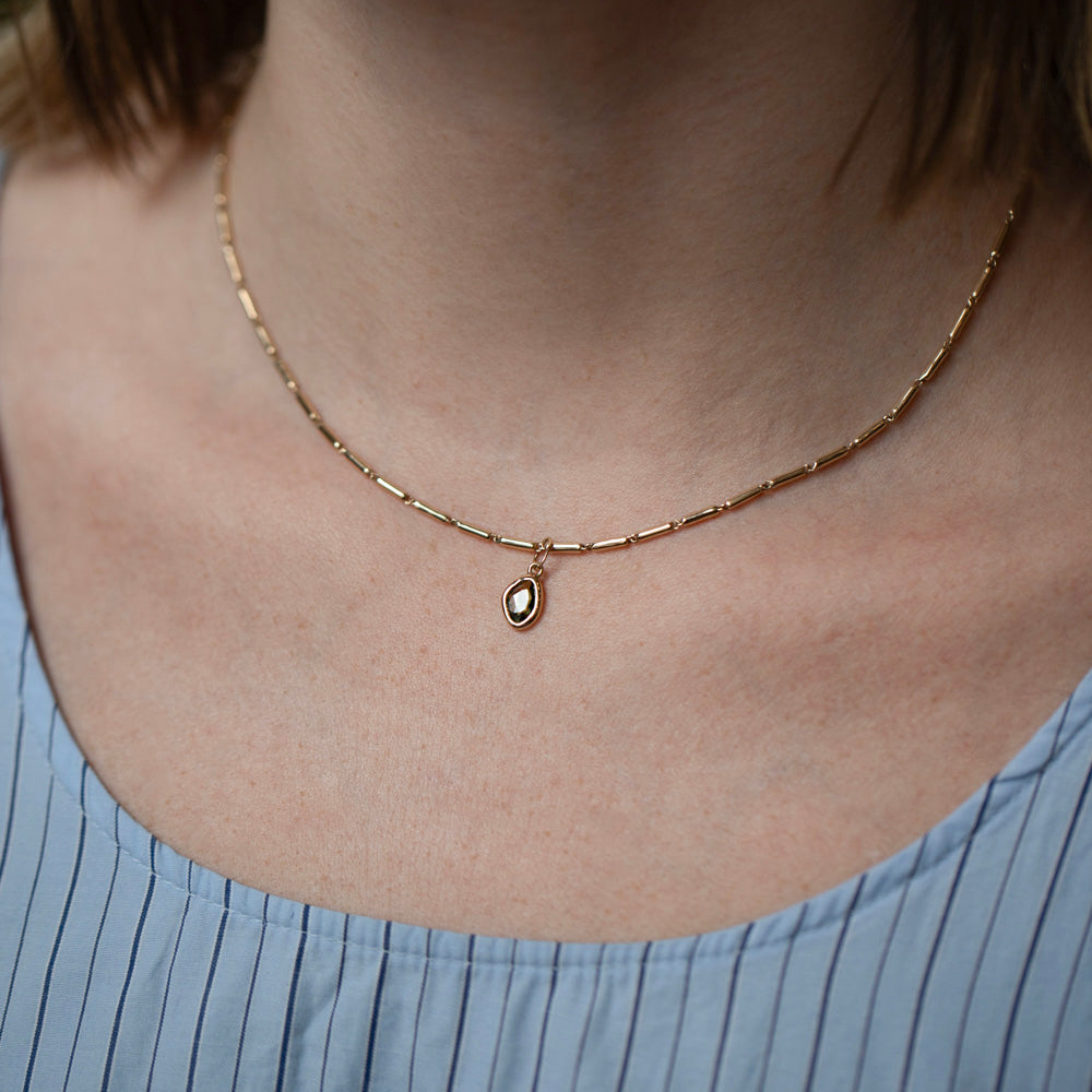 product_details::Gold Butter Chain Necklace and Green Sapphire Gusher Charms on model.
