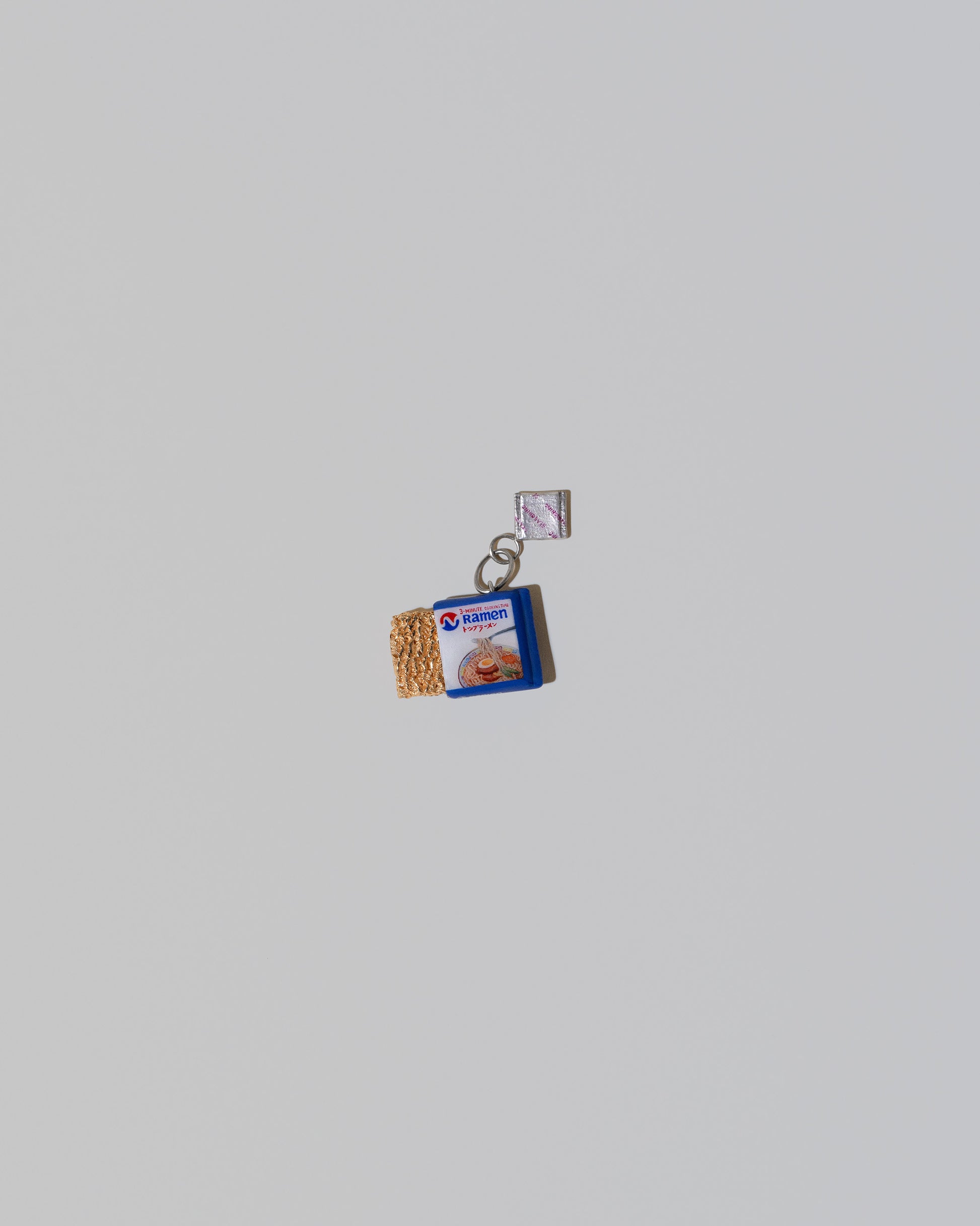 Instant Ramen Charm on light color background.