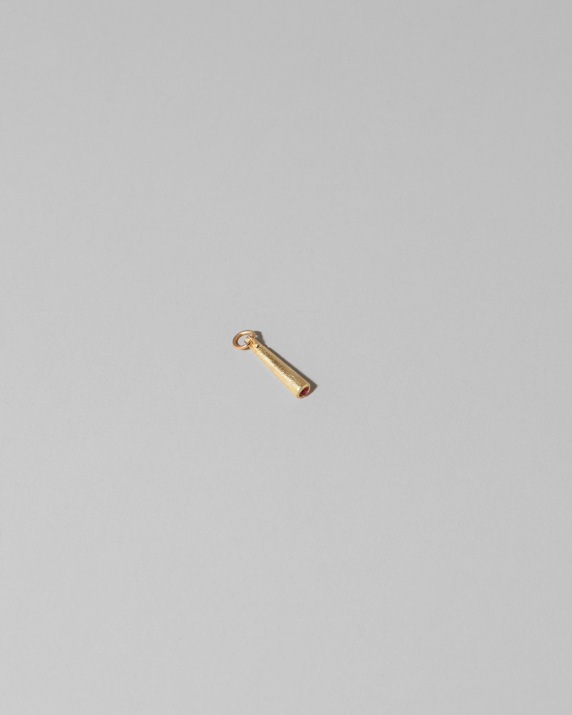 View from the side of the Lit Joint Charm on light color background.