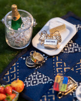 Styled image of the Saltine Charms, with Salted Butter Charm, Caviar Charm and Sardine Can Charm.