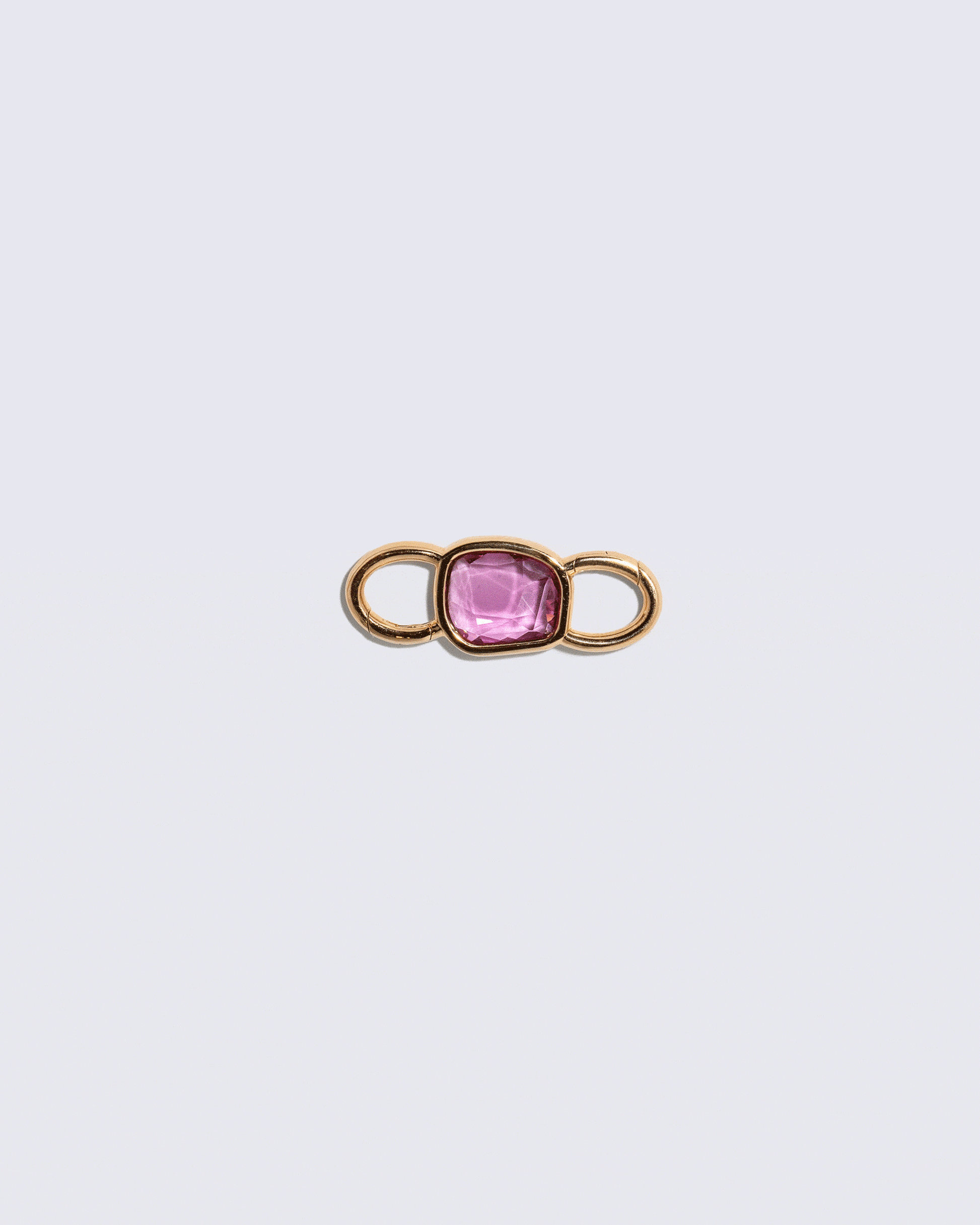 Animated detail view of the double sided Sapphire Gusher Openable Pendant styled with the Link Necklace on light color background.