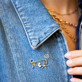 product_details::Spiral Pin Brooch with Loop & Sphere Talisman Charm, Eye Talisman Charm, Gold Small Thousand & One Night Heart Charm, North Star Talisman Charm and Sardine Fish Charm on model. Charms sold separately.