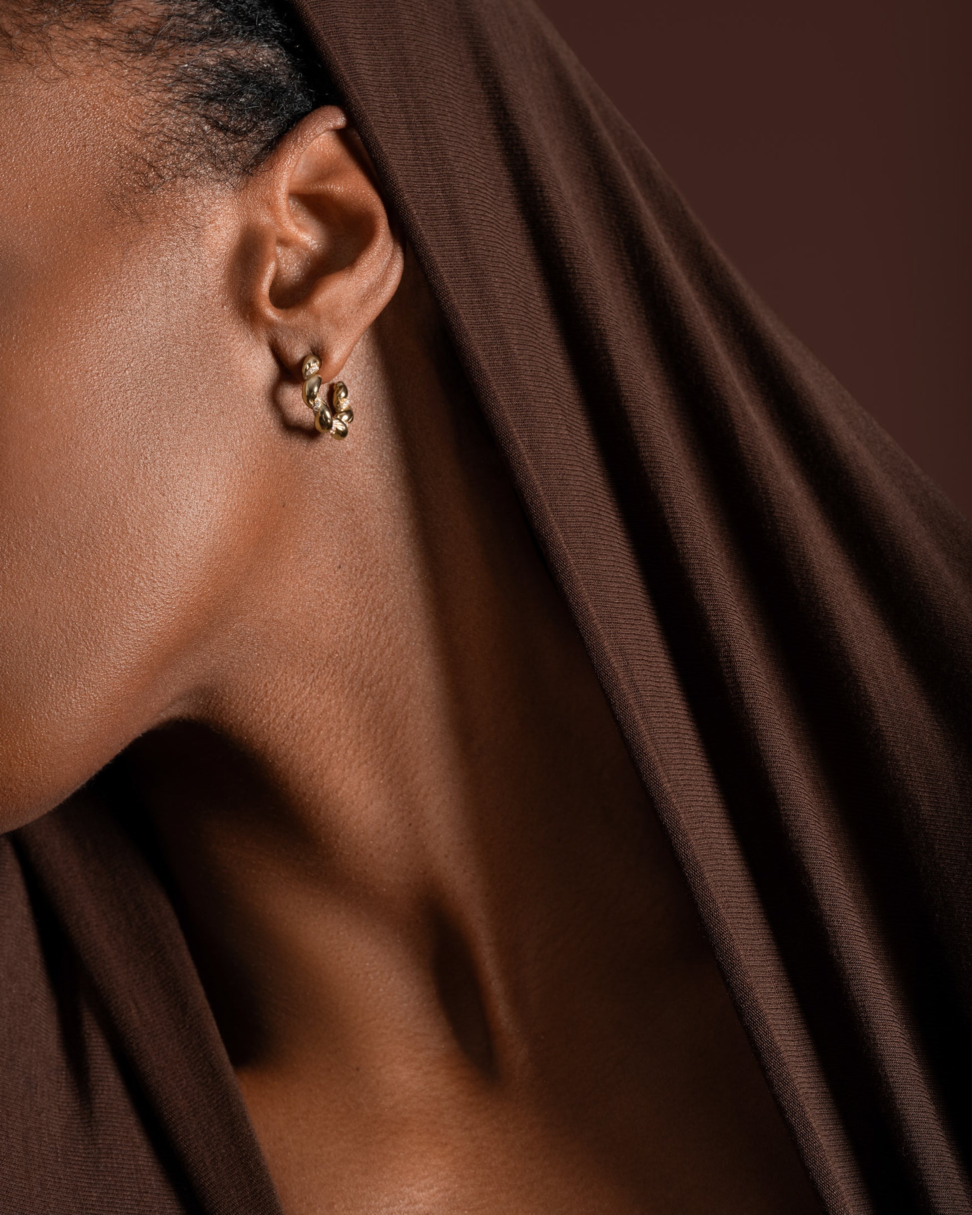 Gold Wrapped Hoop Earrings on model.
