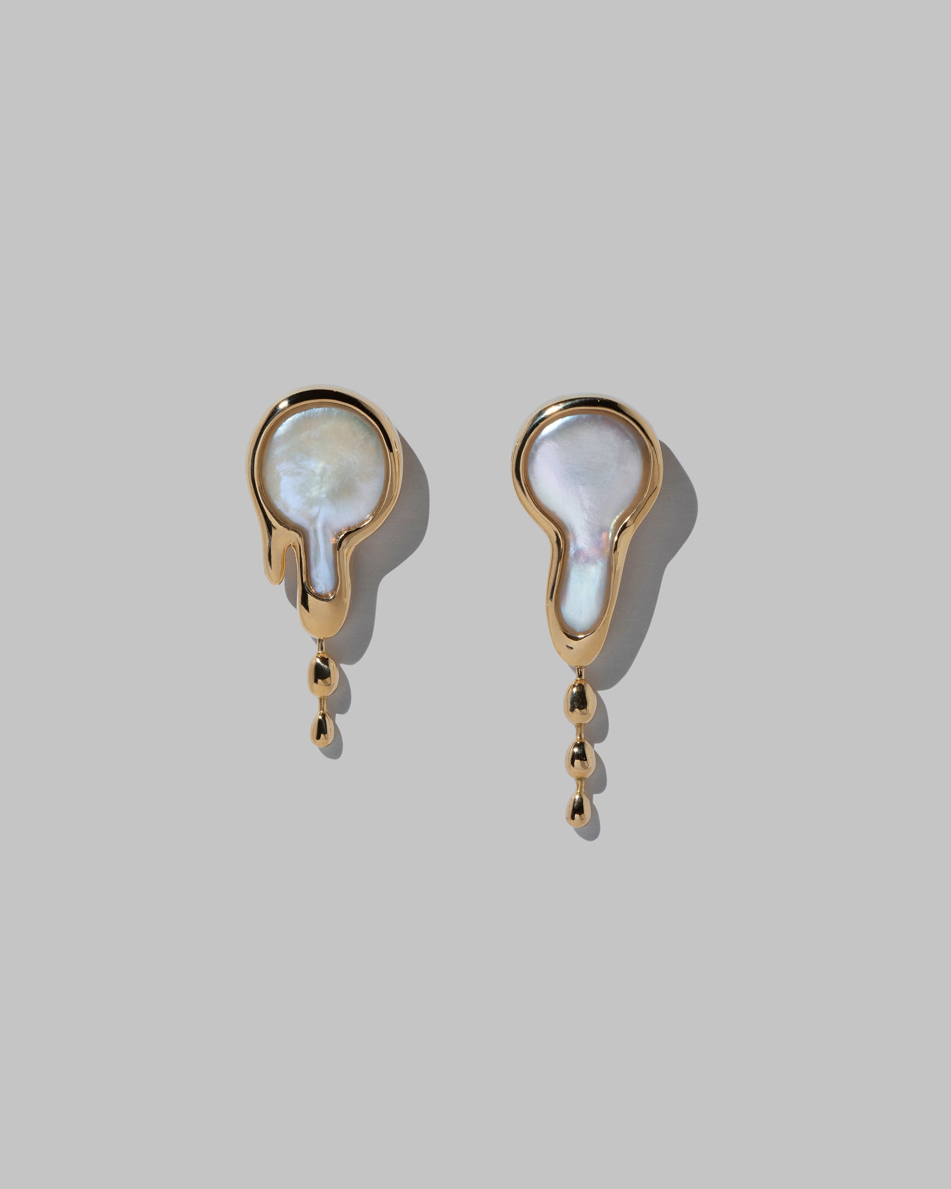 Melt Earrings on light color background.