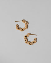 Gold Wrapped Hoop Earrings on light color background.