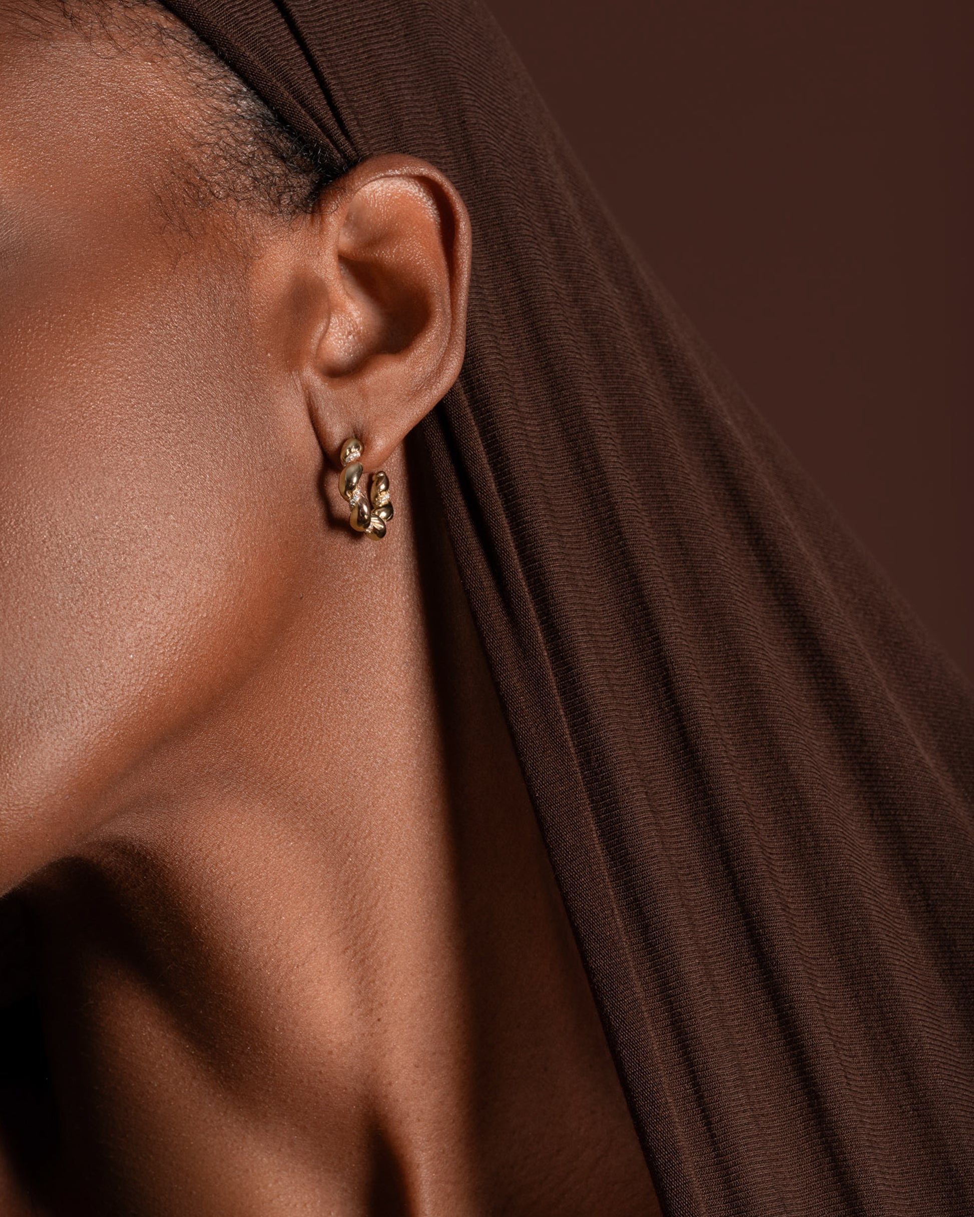 Styled image featuring the Gold Wrapped Hoop Earrings.