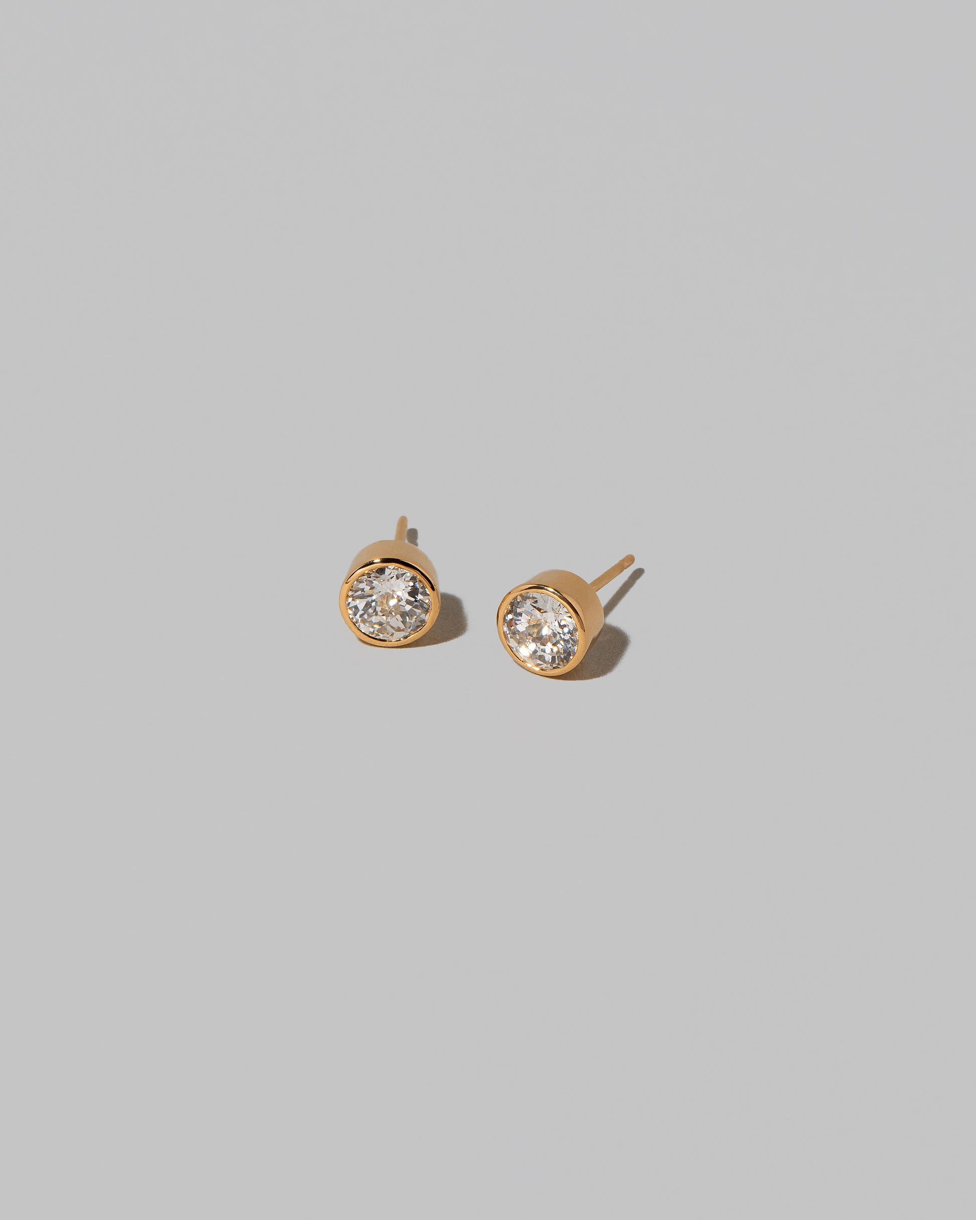 Allium Stud Earrings on light color background.