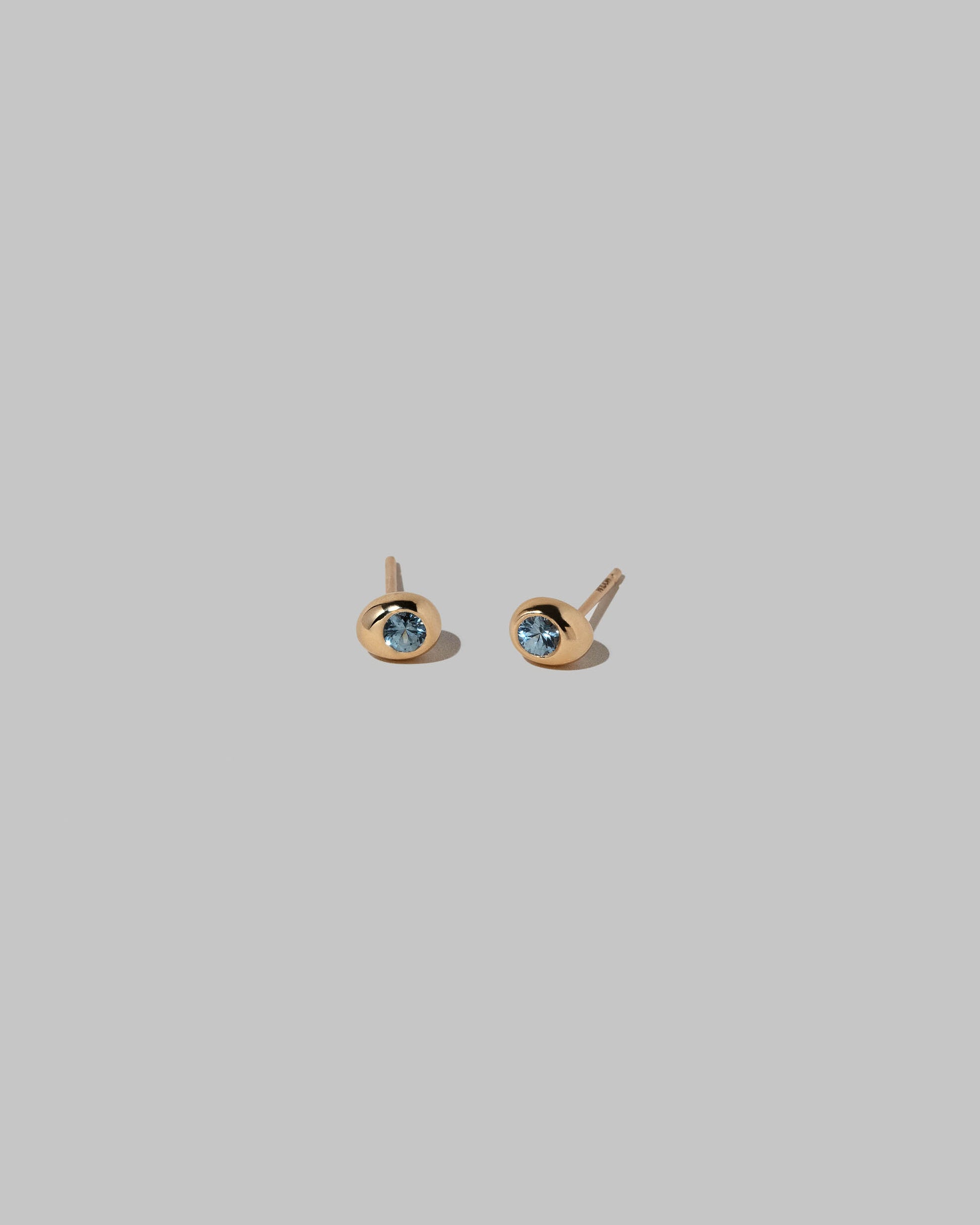 Blue Sapphire Level Stud Earrings on light color background.