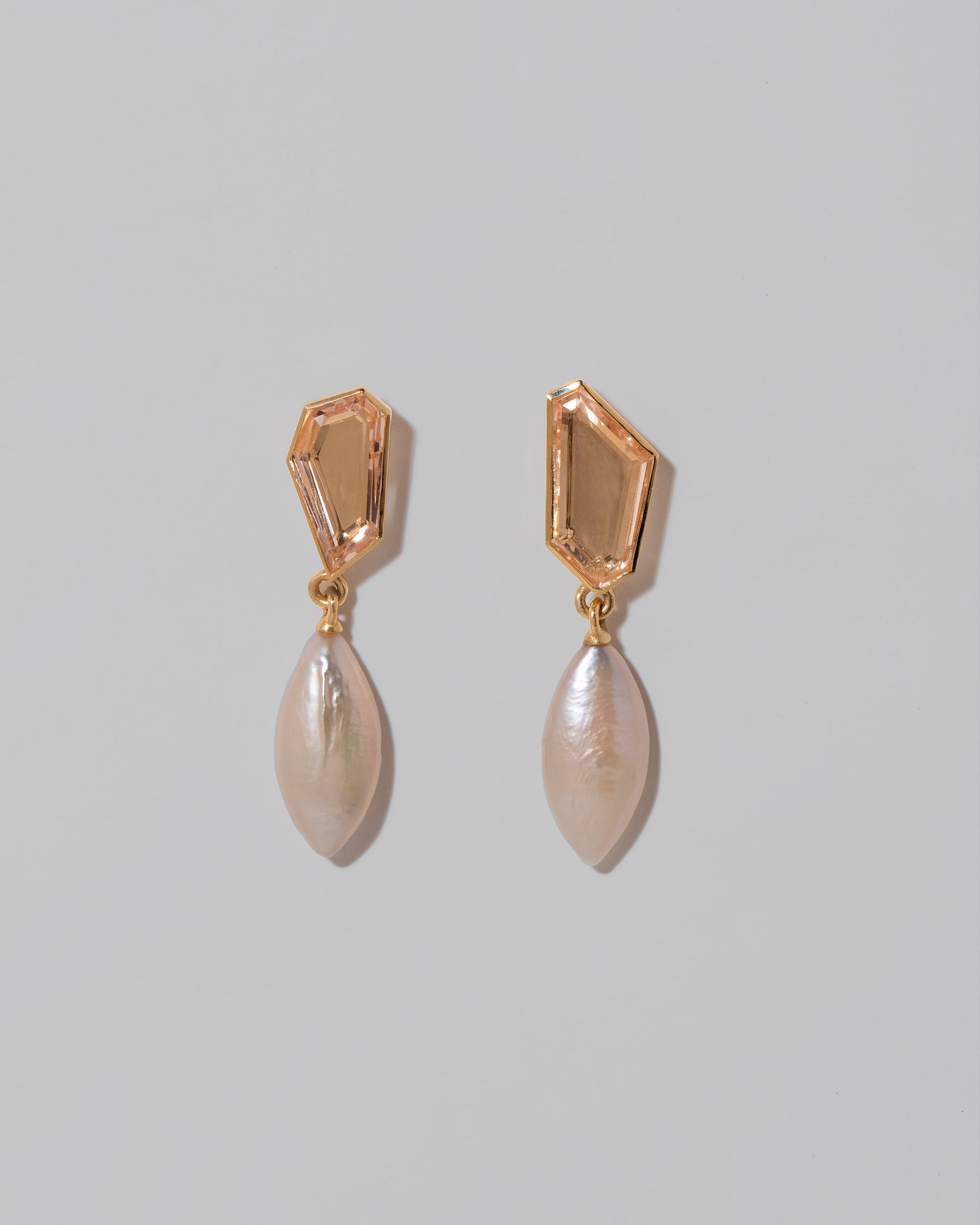 Tricopilia Earrings on light color background.