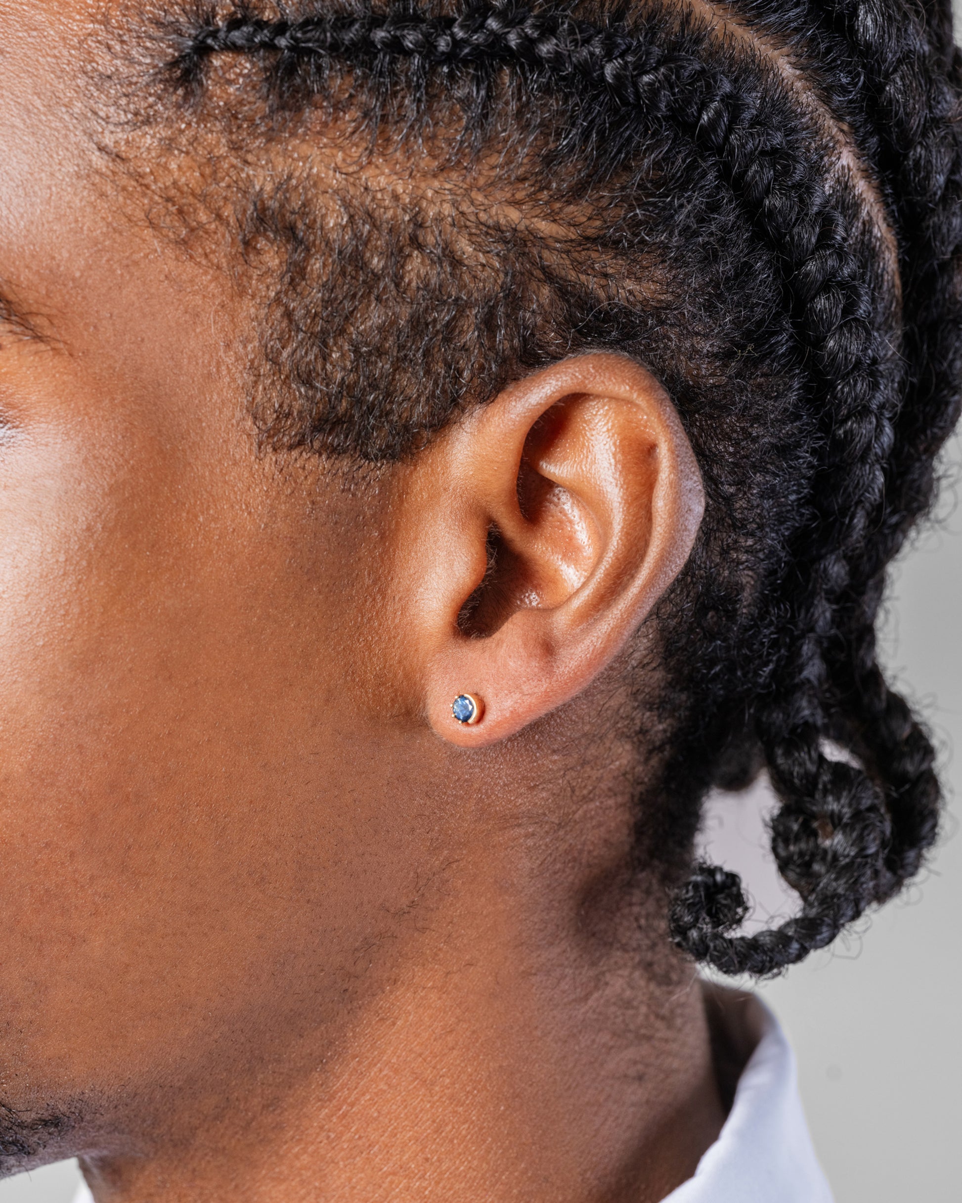 Sapphire Sun & Moon Stud Earrings on male model.