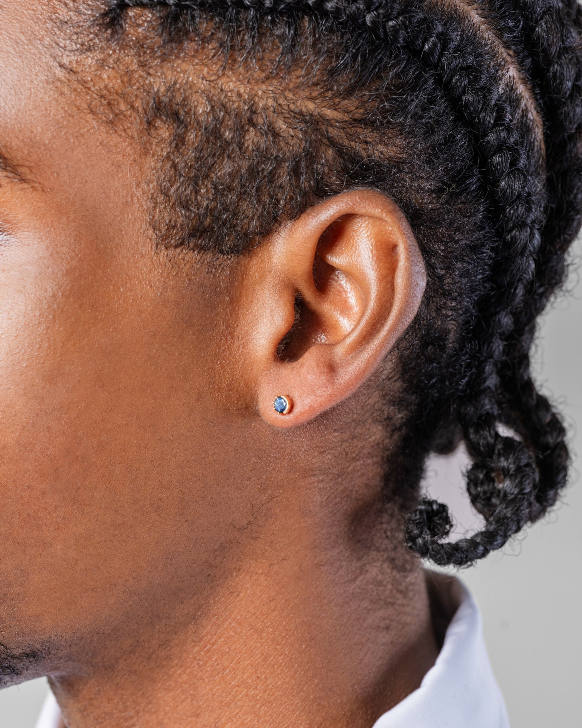 Sapphire Sun & Moon Stud Earrings on male model.