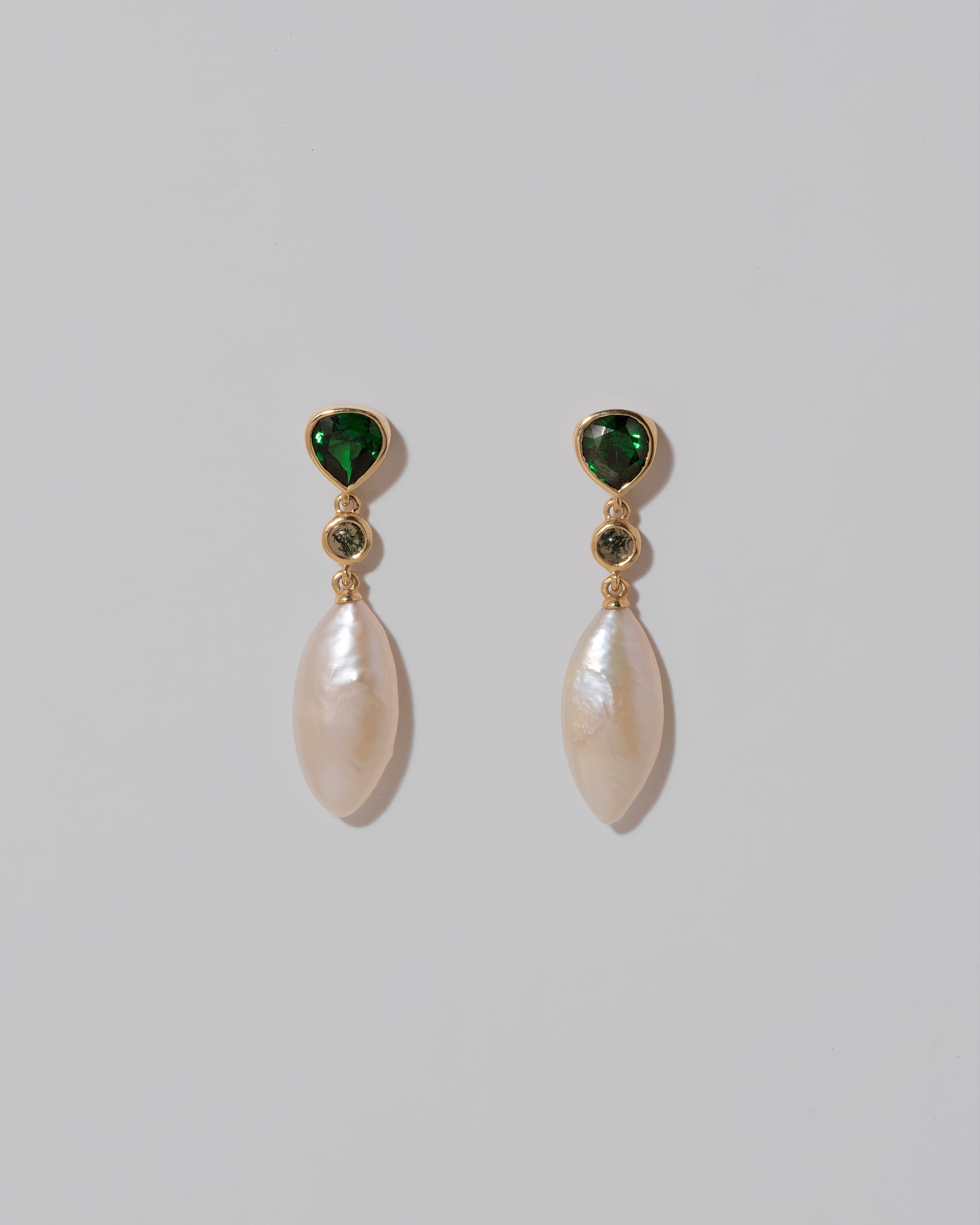 Convallaria Earrings on light color background.