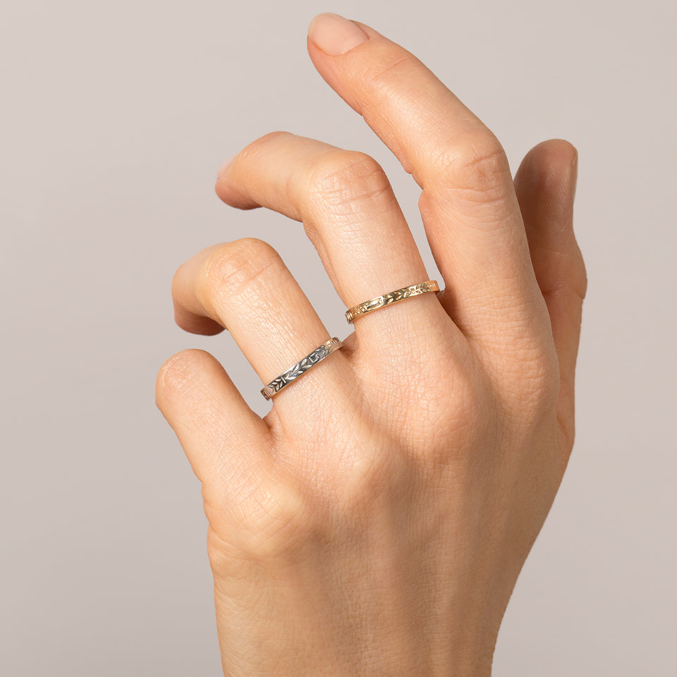 product_details::Platinum 3mm Etched Leaf Band and Gold 3mm Etched Leaf Band on model.