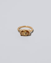 Exhilaration Ring on light color background.