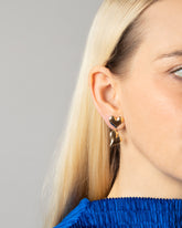 Styled image of model wearing the Thousand & One Night Heart Drop Earrings.