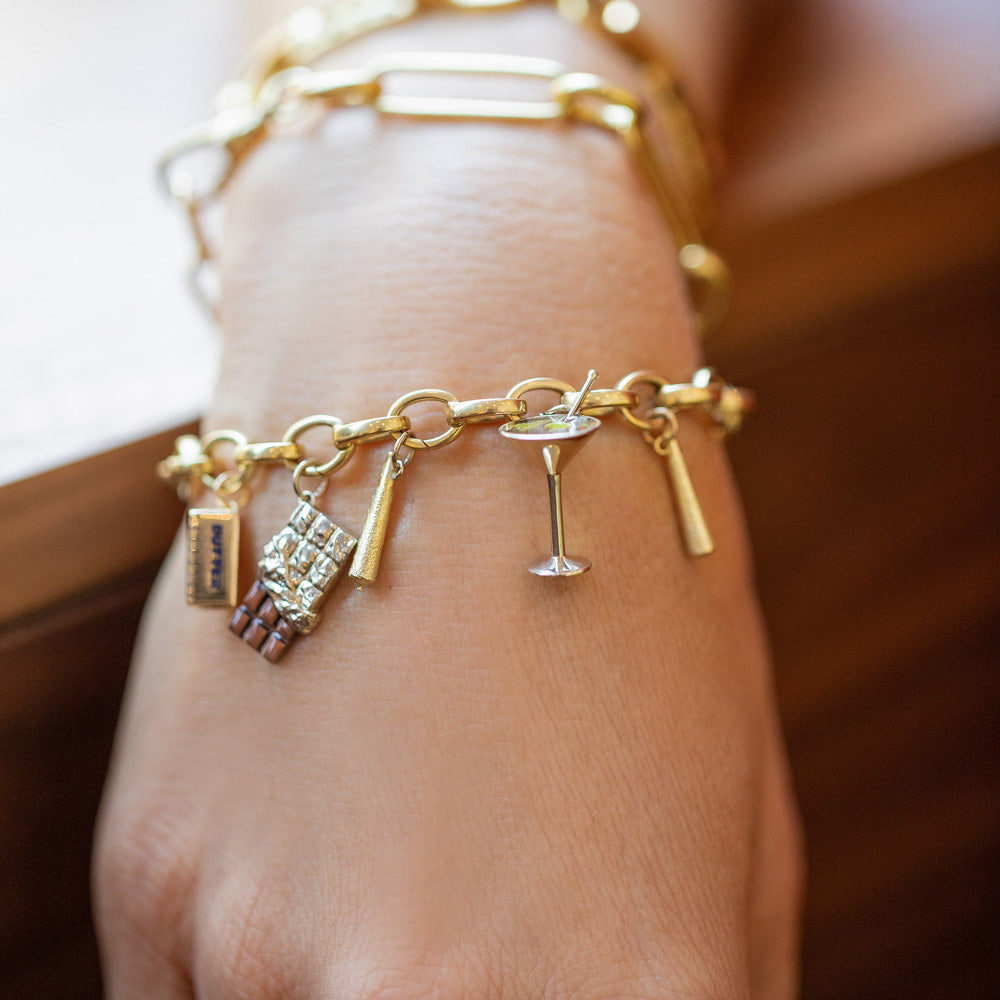 product_details::Stick of Salted Butter Charm, Joint Charms, Chocolate Bar Charm and Dirty Martini Charm paired with Gold Endless Clasp Bracelet on model.