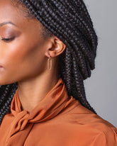 Solid Link Huggie Hoop Earrings on model.