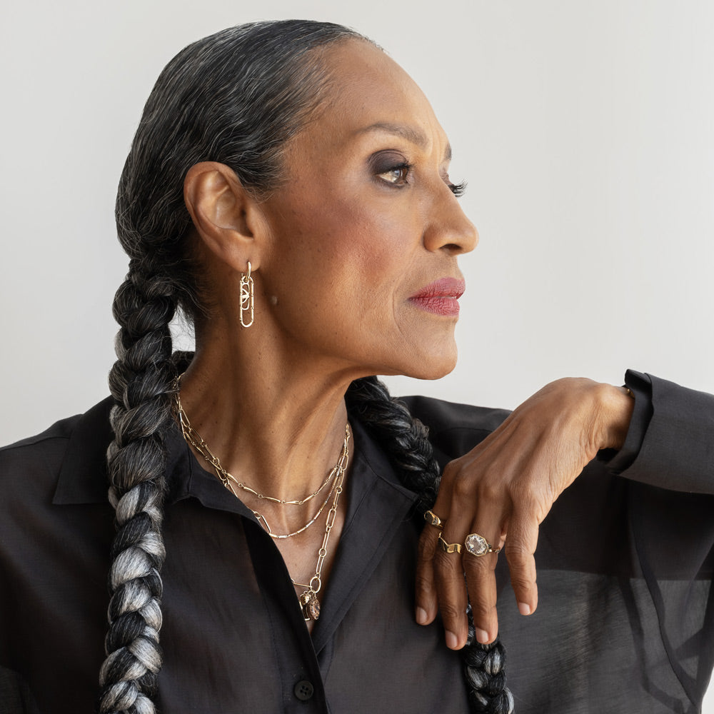 product_details::Styled image on model featuring the Gold 5mm Ripple Band, the Tricolor Butter Chain Necklace, Accumulation Necklace, and Petite Link Necklace with the Curled-Up Cat Charm and Gold Large Thousand & One Night Heart Charm worn on its Oval Openable Link clasp, and the Comsic Balance Styling Link layered with the Butter Chain Styling Link on the Styling Link Huggie Hoop Earrings.
