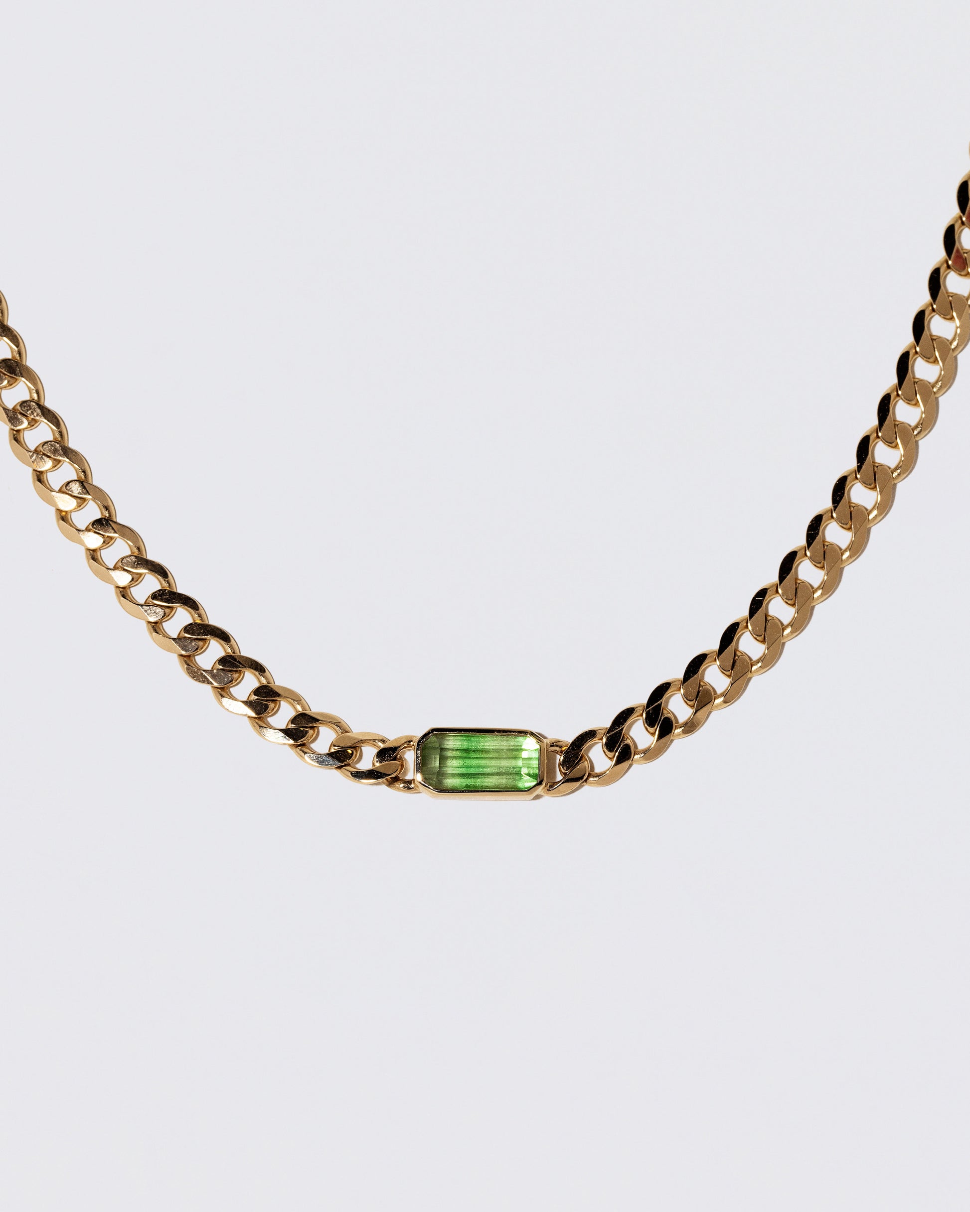 Closeup details of the Identity Chain Bicolor Garnet Necklace 001 on light color background.