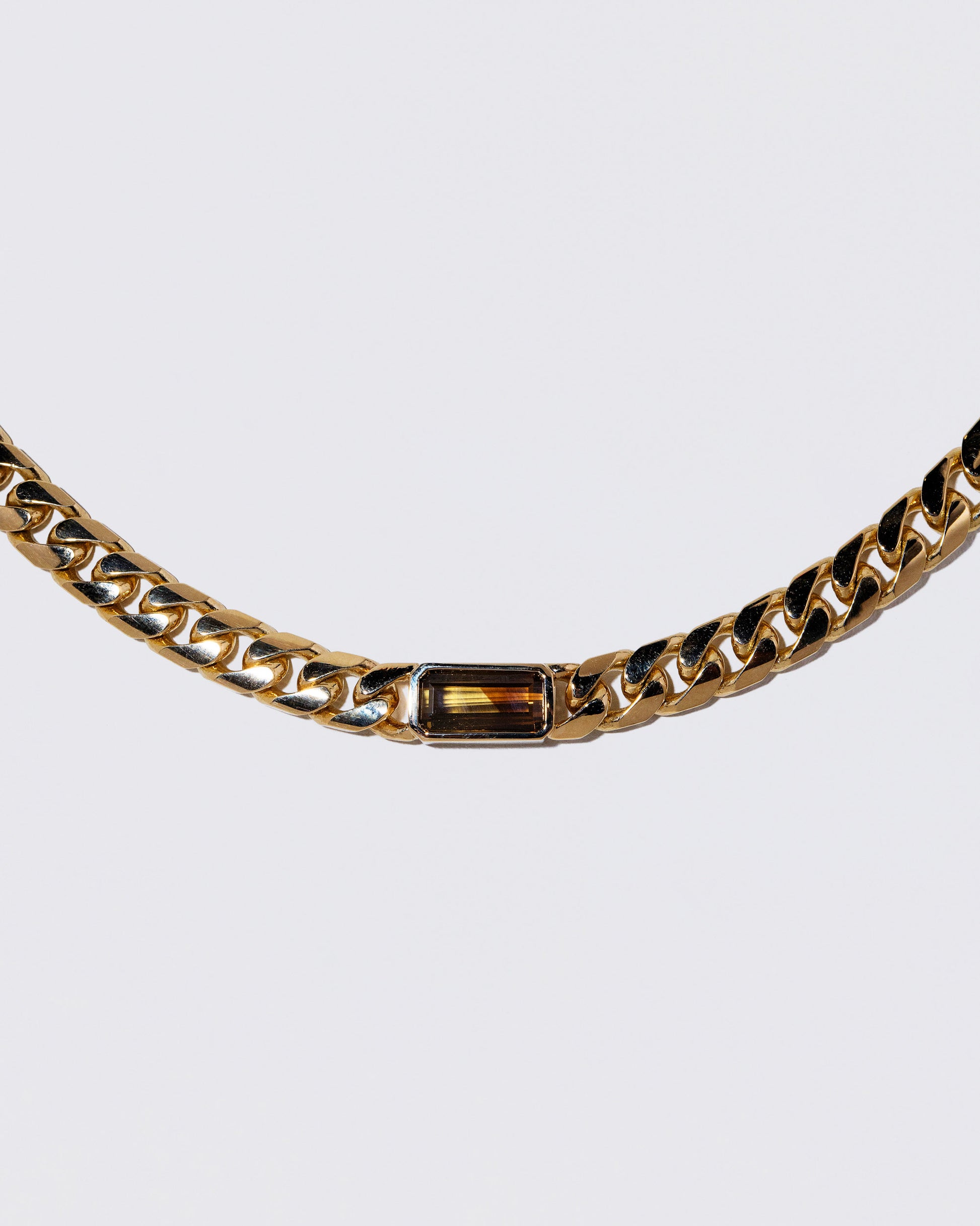 Closeup details of the Identity Chain Chrysoberyl Necklace 001 on light color background.