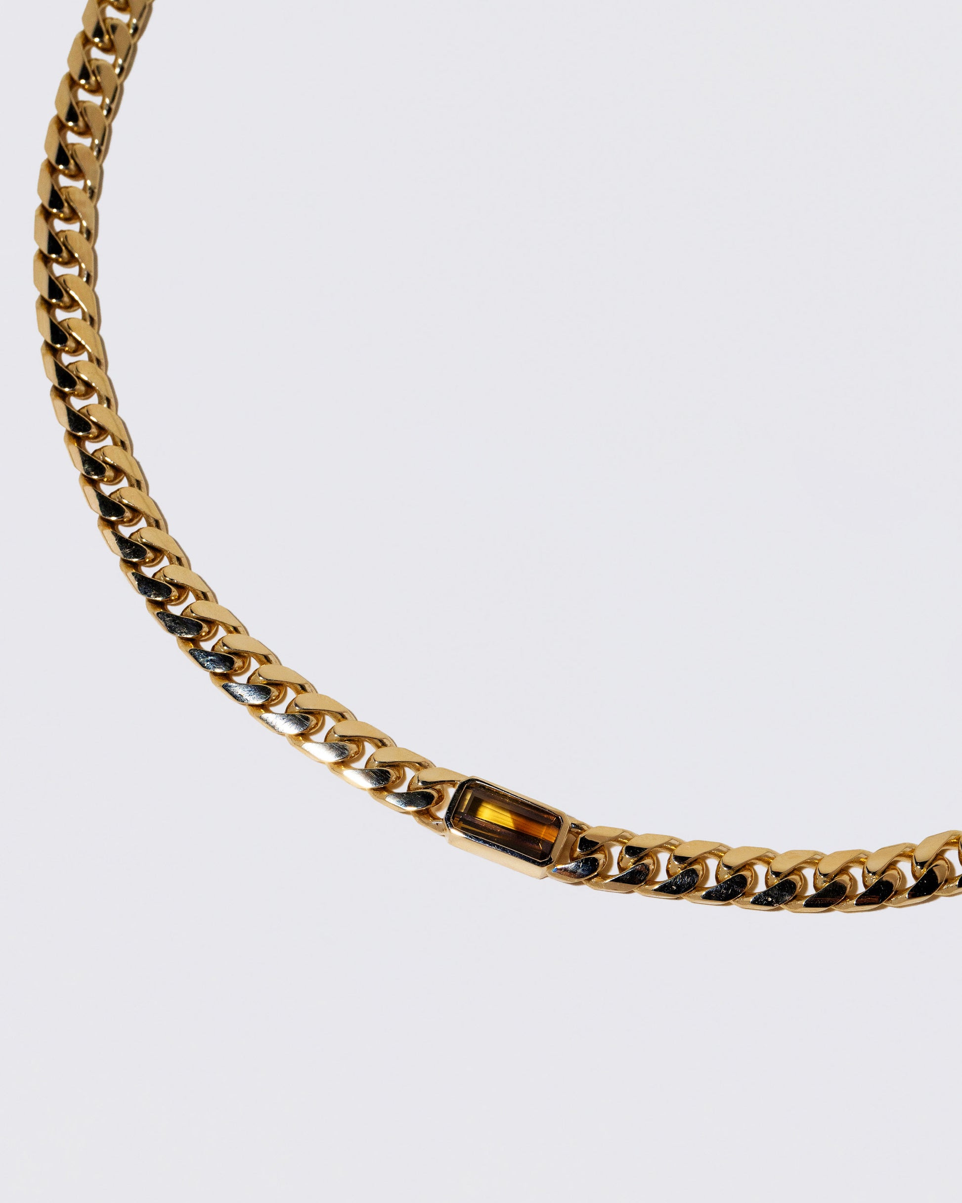 Closeup details of the Identity Chain Chrysoberyl Necklace 001 on light color background.