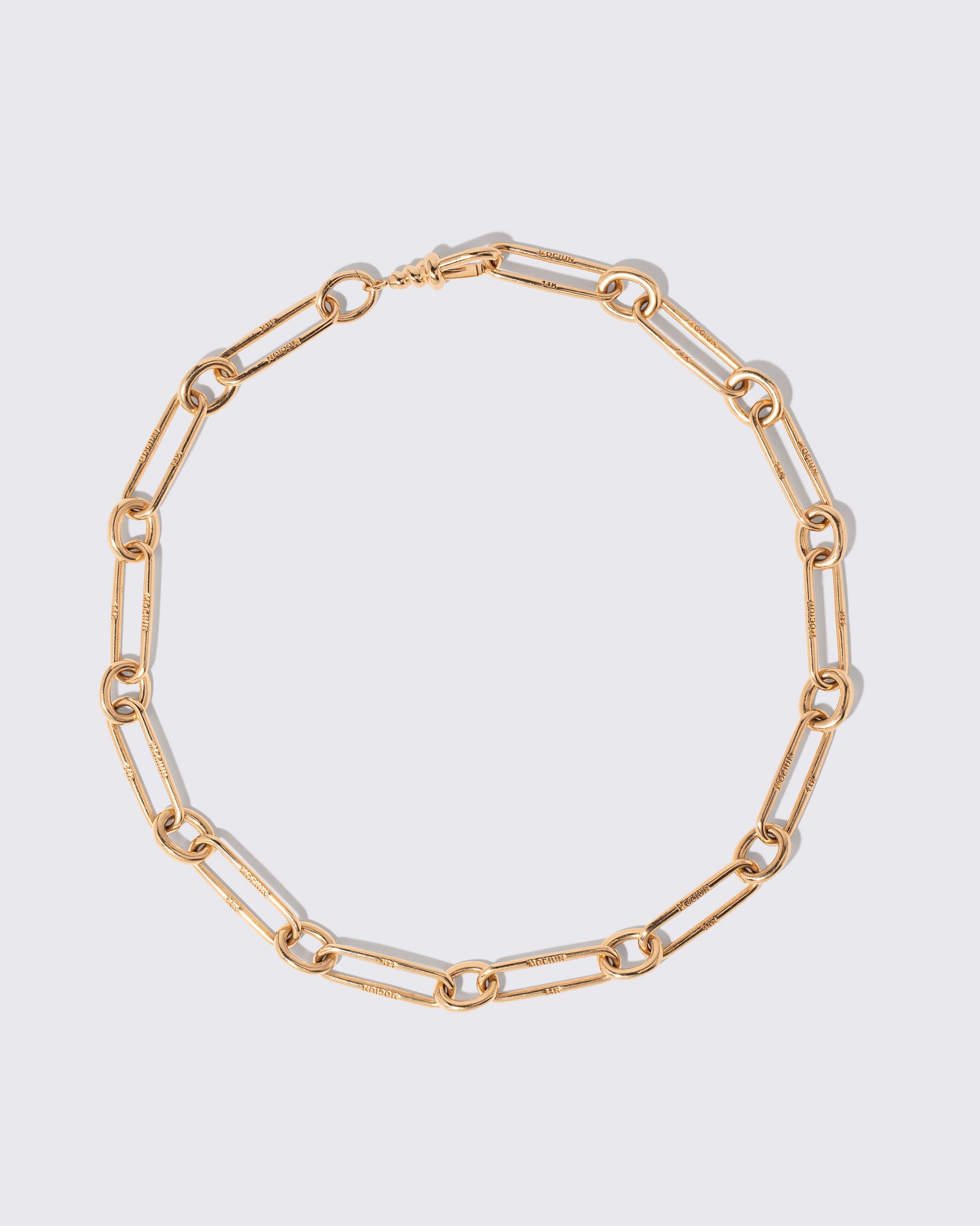 Link Necklace on light color background.