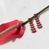 product_details::Styled image of the Flame Earrings on light color background.
