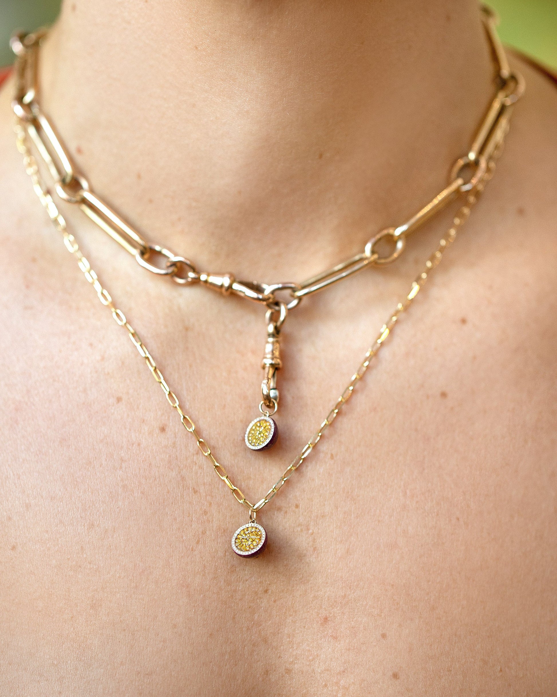 Passion Fruit Charm paired with the Grand Swivel Fob and Solid Link Necklace layered with a Passion Fruit Charm paired with a 3.5mm Beveled Oval Chain Necklace on model. Charms available separately.