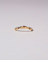 Gold Five Stone Garnet High Peak Band on light color background.