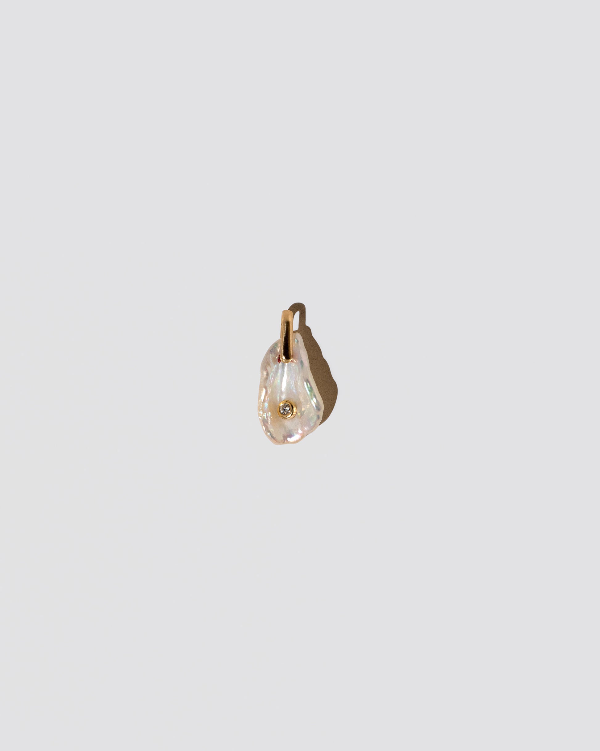 April Birthstone Pearl Pendant With Diamond on light color background.
