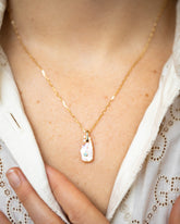 March Birthstone Pearl Pendant With Aquamarine and the Petite Diamond Cut Chain Necklace on model.