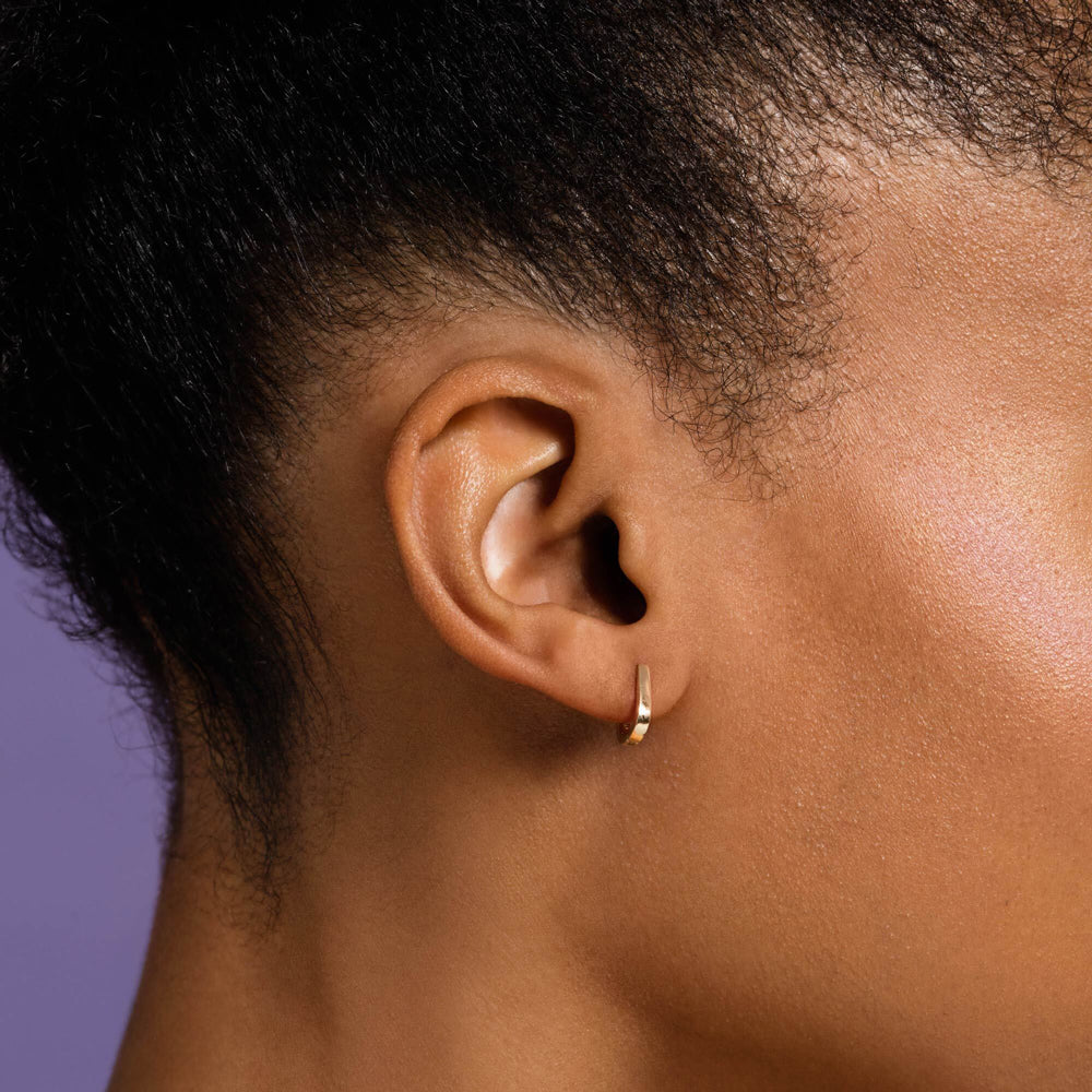 product_details::Poppy Flower Bud Hoop Earrings on model.