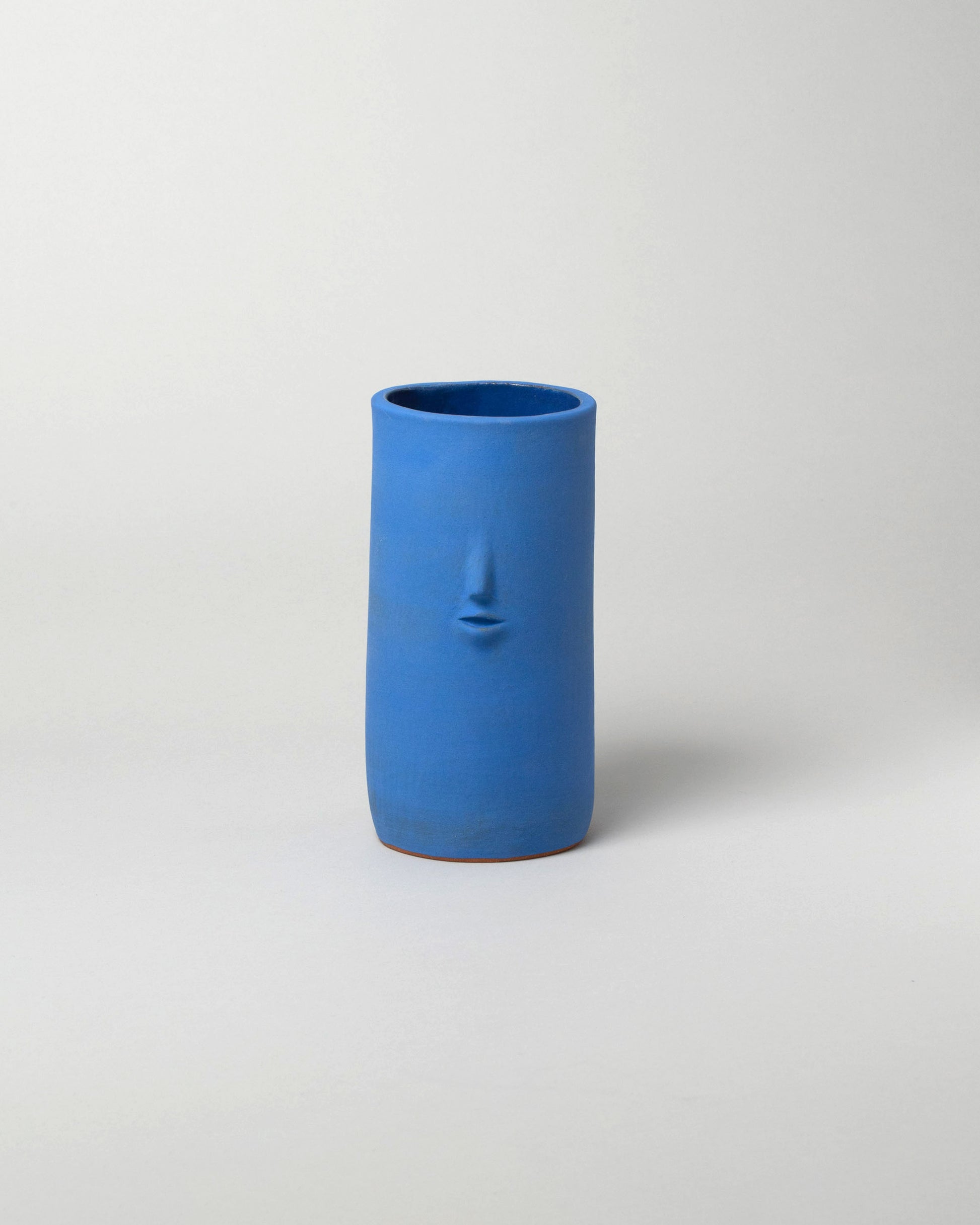 Rami Kim Matte Blue Face Vase on light color background.