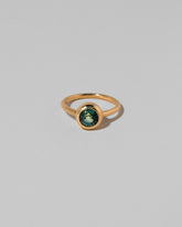 Teal Sapphire Wellspring Ring on light color background.