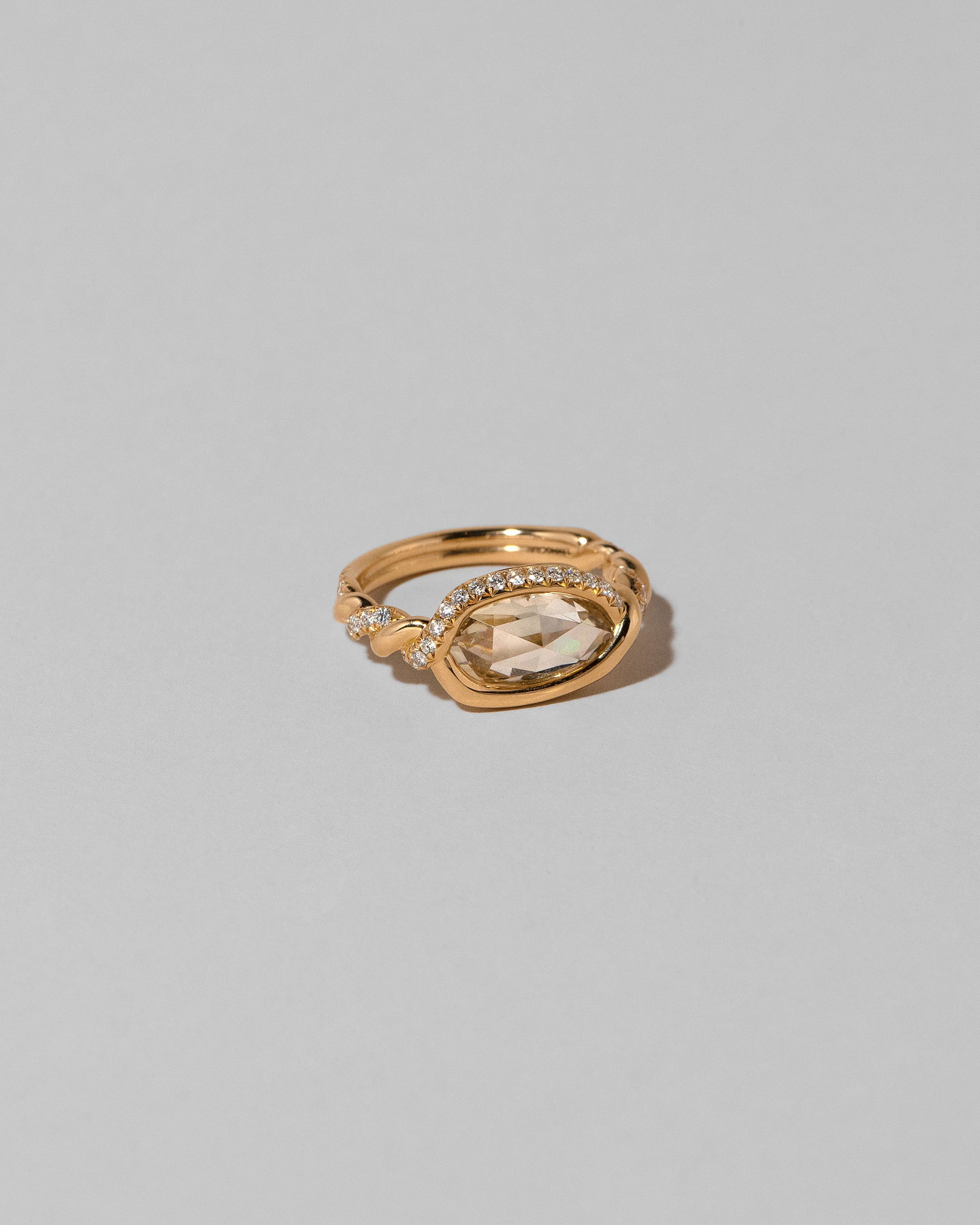 View from the side of the Encircle Ring on light color background.