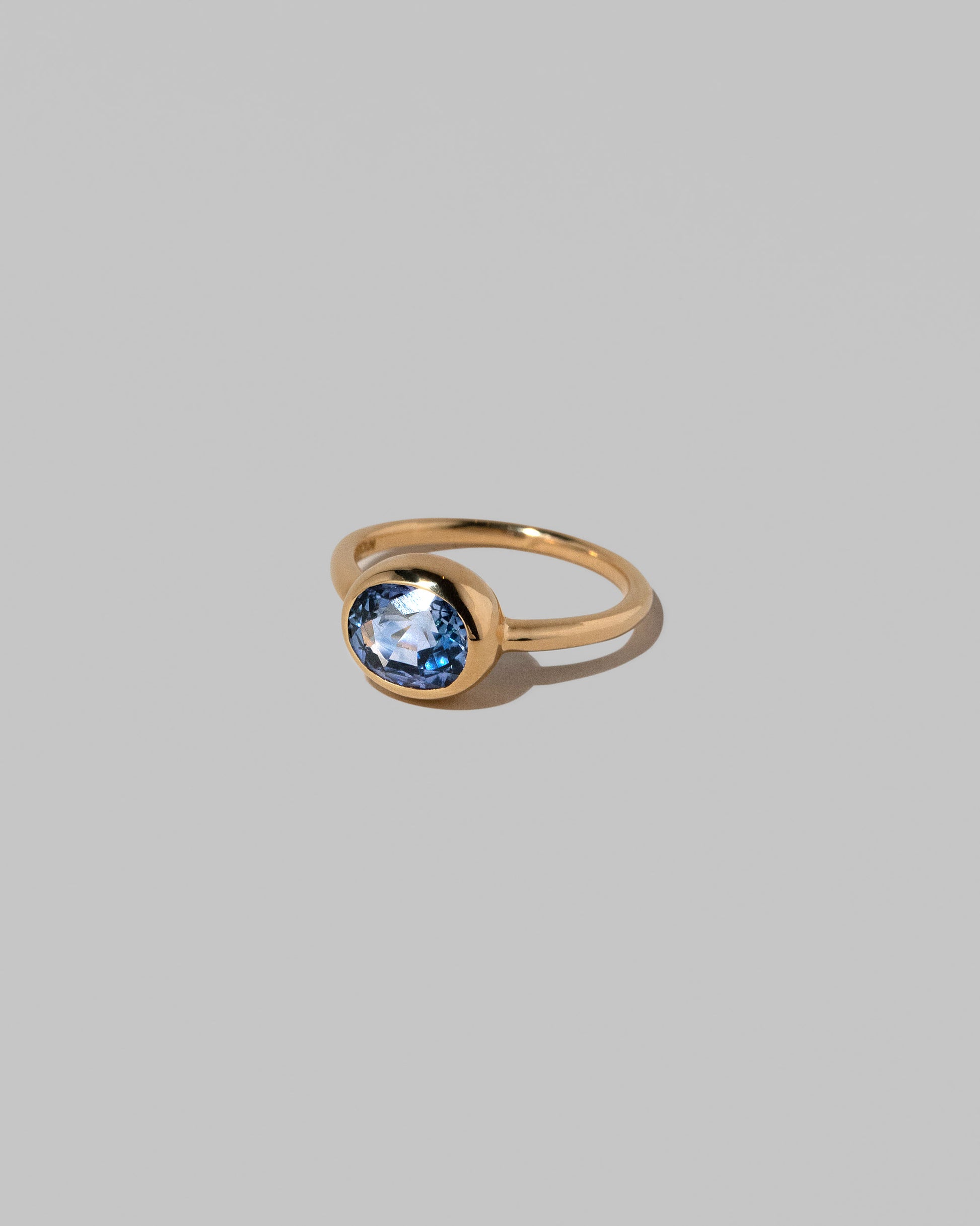 View from the side of the Geyser Blue Sapphire Ring 002 on light color background.
