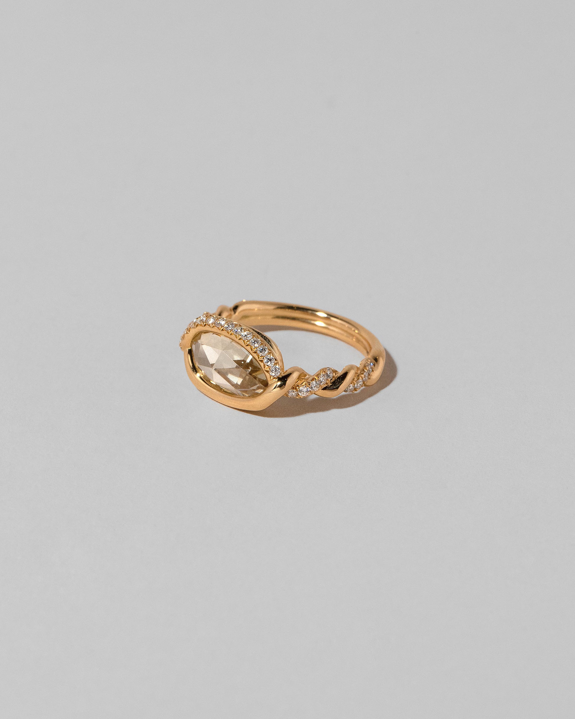 View from the side of the Encircle Ring on light color background.