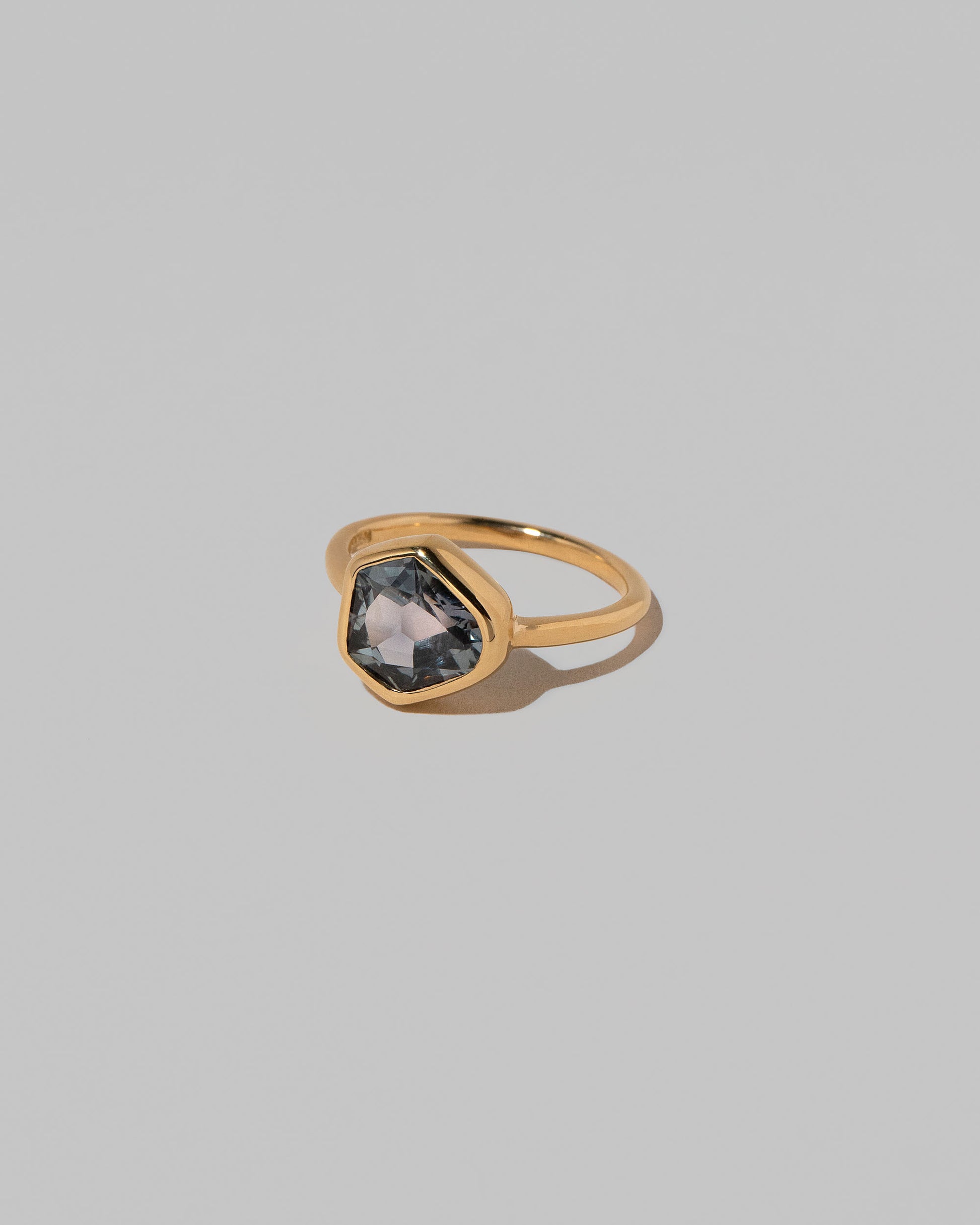 View from the side of the Geyser Purple Sapphire Ring 003 on light color background.