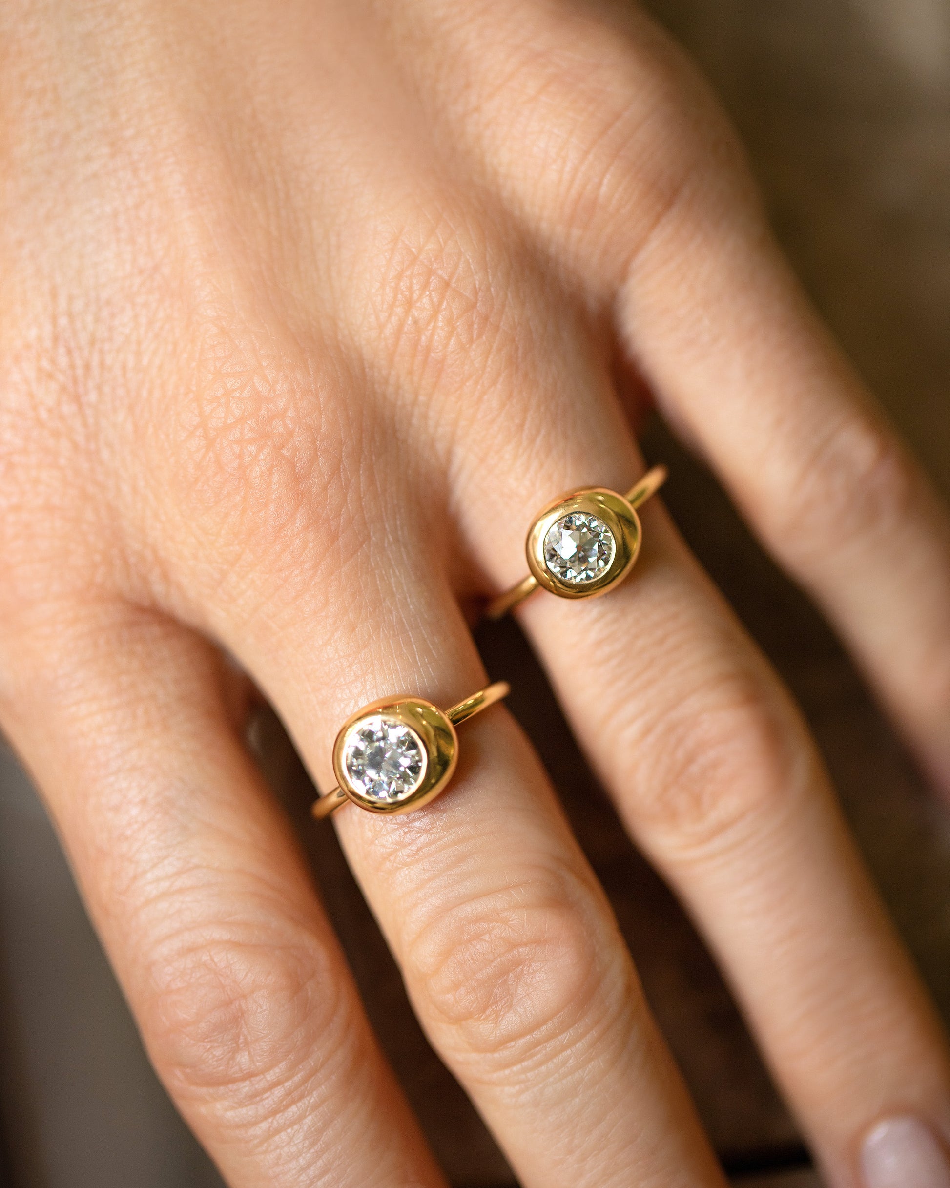 Diamond Grand Level Ring and Diamond Level Ring on model.